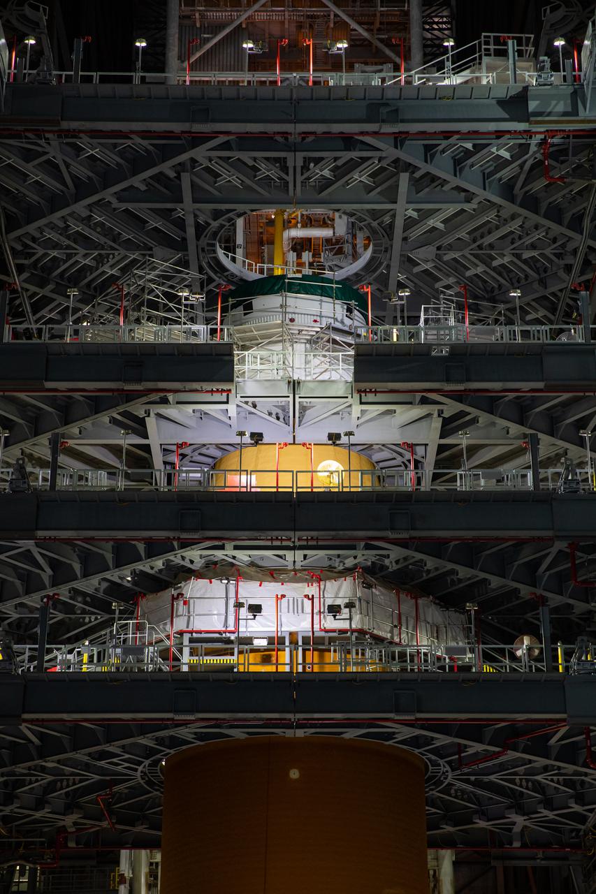 Inside NASA’s iconic Vehicle Assembly Building at Kennedy Space Center in Florida, teams from Exploration Ground Systems and contractor Jacobs mate the Orion Stage Adapter (OSA) to the Interim Cryogenic Propulsion Stage (ICPS) on top of the Space Launch System (SLS) on Oct. 9, 2021. The addition of the OSA marks the last piece of SLS rocket hardware to be added before crews soon add the Orion spacecraft and its launch abort system on top of the OSA. The ring-shaped OSA is filled with 10 shoebox-sized CubeSats that will deploy when the ICPS separates from Orion on its way to the Moon during Artemis I, which will be the first integrated flight test of the SLS and Orion spacecraft. In later missions, NASA will land the first woman and the first person of color on the surface of the Moon, paving the way for a long-term lunar presence and serving as a steppingstone on the way to Mars. 