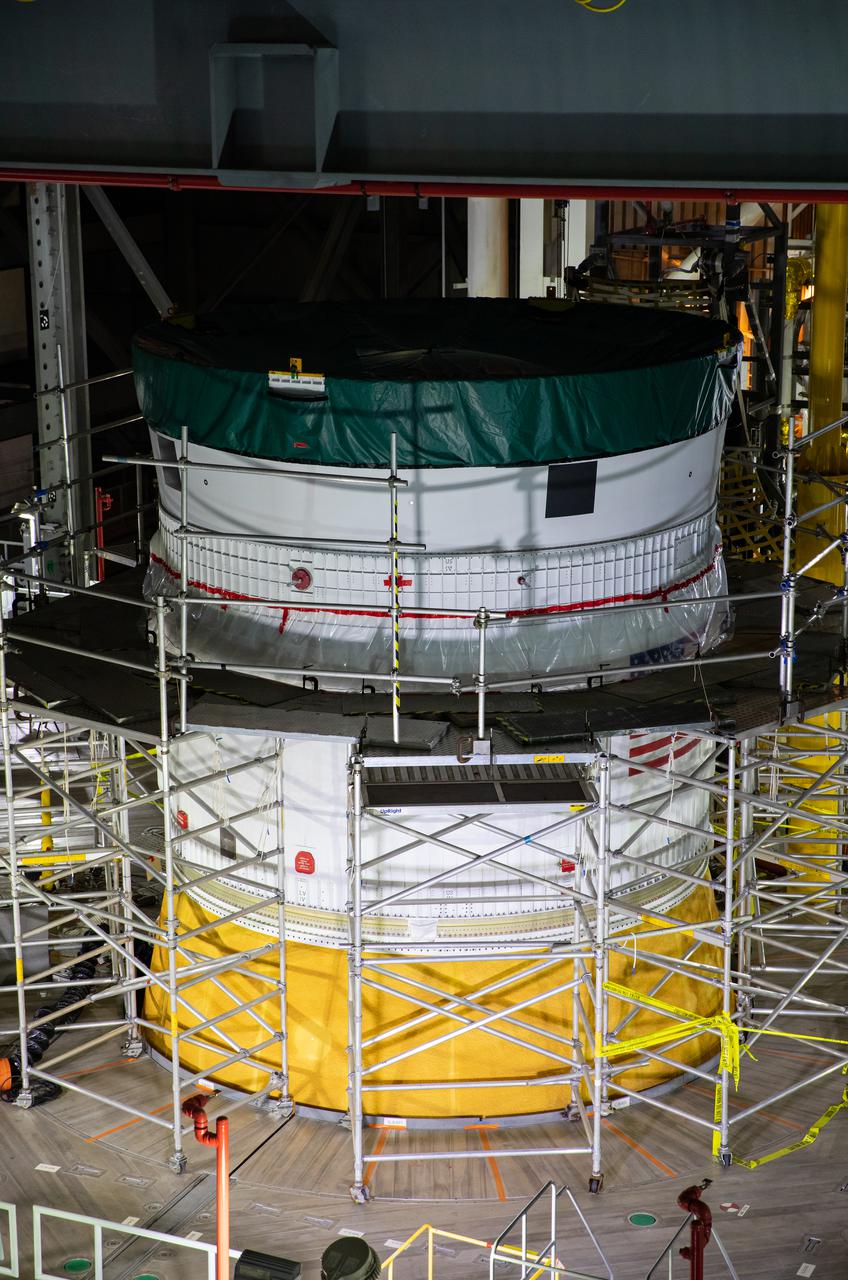 Inside NASA’s iconic Vehicle Assembly Building at Kennedy Space Center in Florida, teams from Exploration Ground Systems and contractor Jacobs mate the Orion Stage Adapter (OSA) to the Interim Cryogenic Propulsion Stage (ICPS) on top of the Space Launch System (SLS) on Oct. 9, 2021. The addition of the OSA marks the last piece of SLS rocket hardware to be added before crews soon add the Orion spacecraft and its launch abort system on top of the OSA. The ring-shaped OSA is filled with 10 shoebox-sized CubeSats that will deploy when the ICPS separates from Orion on its way to the Moon during Artemis I, which will be the first integrated flight test of the SLS and Orion spacecraft. In later missions, NASA will land the first woman and the first person of color on the surface of the Moon, paving the way for a long-term lunar presence and serving as a steppingstone on the way to Mars. 