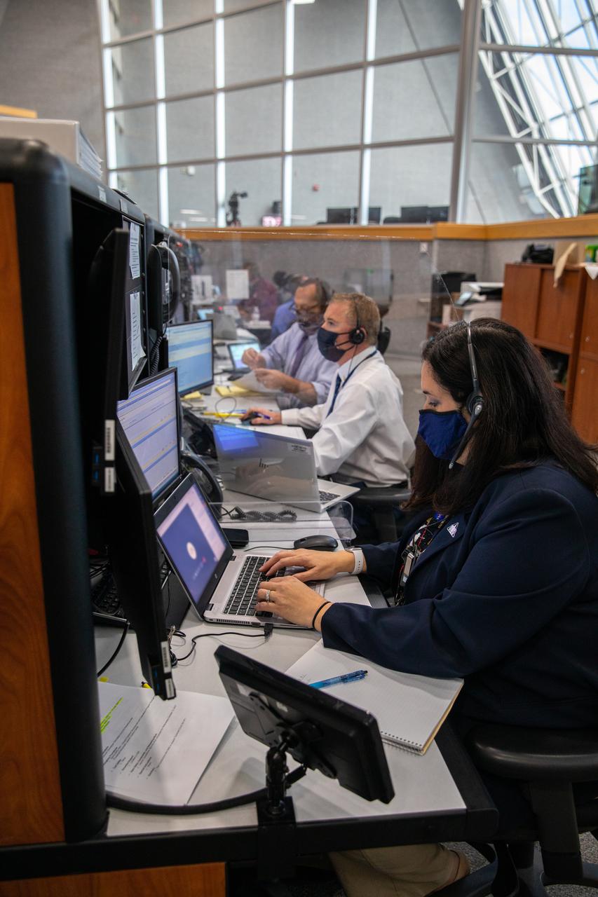 From left, John Kracsun and Keith Lawton, test conductors for contractor Jacobs, and Melissa Jones, Landing and Recovery director, NASA’s Exploration Ground Systems, participate in the 11th terminal countdown simulation for the Artemis I launch inside Kennedy Space Center’s Launch Control Center on Oct. 14, 2021. The event marked the first time members of NASA’s mission management team, launch team, and Jacobs conducted the simulation together. During Artemis I, the agency’s Orion spacecraft will lift off from Kennedy aboard NASA’s most powerful rocket – the Space Launch System – to fly farther than any spacecraft built for humans has ever flown. Through NASA’s Artemis missions, the agency, along with commercial and international partners, will establish a sustainable human presence on the Moon to prepare for missions to Mars.
