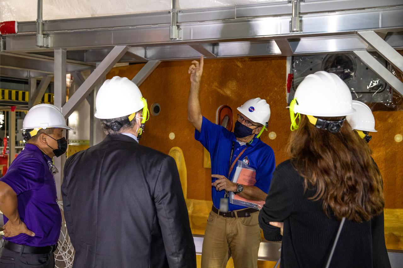 NASA’s Orion Program and Lockheed Martin management tour the Vehicle Assembly at NASA’s Kennedy Space Center in Florida on Oct. 15, 2021. Speaking to the group about the Space Launch System integration is Mike Bolger, Kennedy’s Exploration Ground Systems manager. The Orion spacecraft for NASA’s Artemis I mission, fully assembled with its launch abort system, is stacked on top of the Space Launch System rocket in High Bay 3. Launching in 2021, Artemis I will be an uncrewed test flight of the Orion spacecraft and Space Launch System rocket as an integrated system ahead of crewed flights to the Moon. Under Artemis, NASA aims to land the first woman and first person of color on the Moon and establish sustainable lunar exploration. 