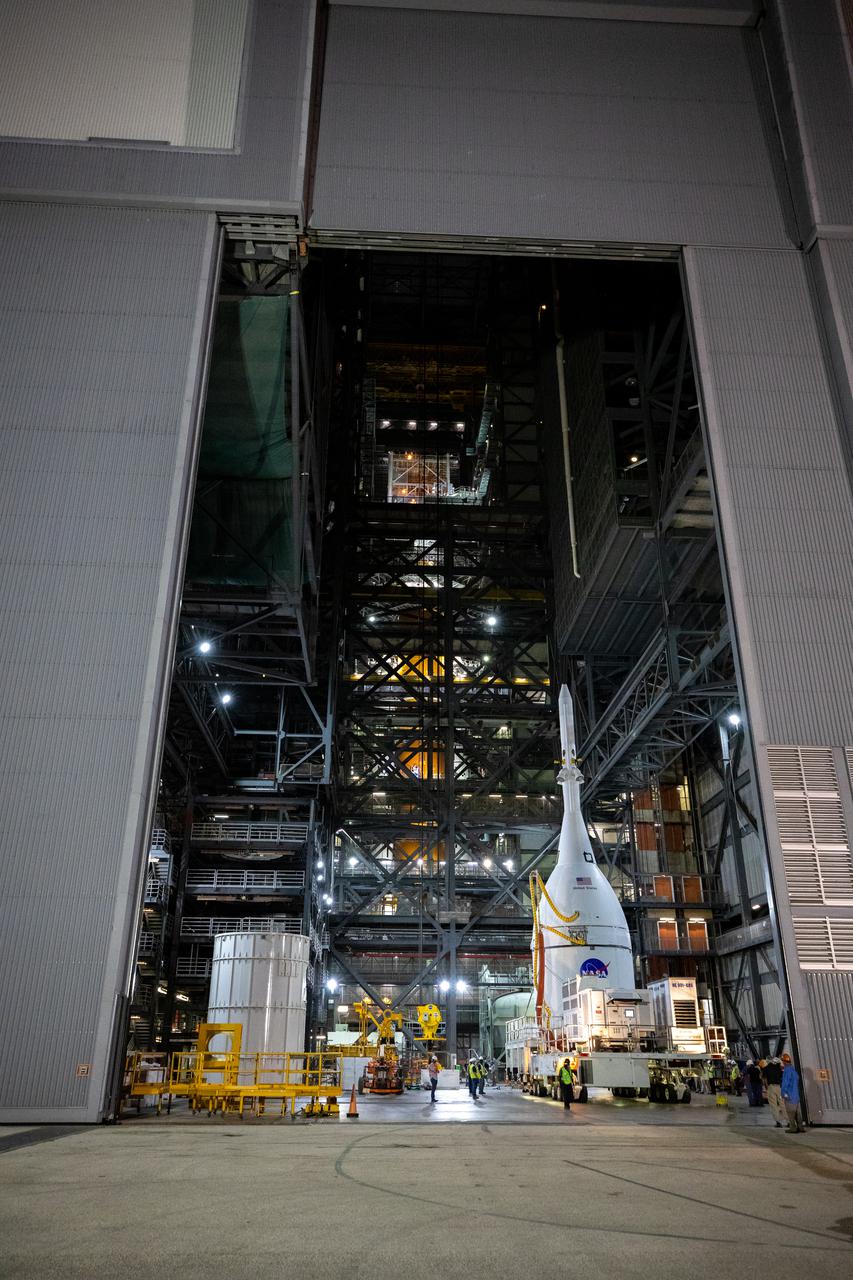 The Orion spacecraft for NASA’s Artemis I mission, fully assembled with its launch abort system, is moved into the transfer aisle of the Vehicle Assembly Building (VAB) at Kennedy Space Center in Florida on Oct. 19, 2021. In the VAB, Orion will join the already stacked flight hardware and be raised into position atop the Space Launch System rocket in High Bay 3. Launching in 2021, Artemis I will be an uncrewed test flight of the Orion spacecraft and Space Launch System rocket as an integrated system ahead of crewed flights to the Moon. Under Artemis, NASA aims to land the first woman and first person of color on the Moon and establish sustainable lunar exploration. 