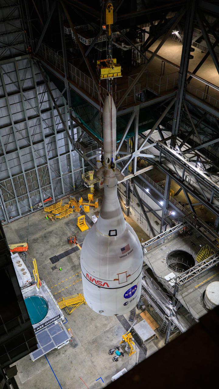 The Orion spacecraft for NASA’s Artemis I mission, fully assembled with its launch abort system, was lifted up and placed on top of the Space Launch System (SLS) rocket in High Bay 3 of the Vehicle Assembly Building at Kennedy Space Center in Florida on Oct. 20, 2021. The stacking of Orion on top of the SLS completes assembly for the Artemis I flight test. Teams will begin conducting a series of verification tests ahead of rolling out to Launch Complex 39B for the Wet Dress Rehearsal. Artemis I will be an uncrewed test flight of the Orion spacecraft and Space Launch System rocket as an integrated system ahead of crewed flights to the Moon. Under Artemis, NASA aims to land the first woman and first person of color on the Moon and establish sustainable lunar exploration. 