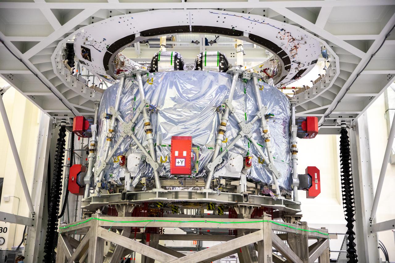 The European-built Service Module (ESM) for NASA’s Artemis II mission shown in a work stand inside the high bay of the Neil A. Armstrong Operations and Checkout Building at NASA’s Kennedy Space Center in Florida on Oct. 15, 2021. Teams from NASA, Lockheed Martin, the European Space Agency and Airbus prepare the service module to be integrated with the Orion crew module adapter and crew module, already housed in the facility. The powerhouse that will fuel and propel Orion in space, the ESM for Artemis II will be the first Artemis mission flying crew aboard Orion.