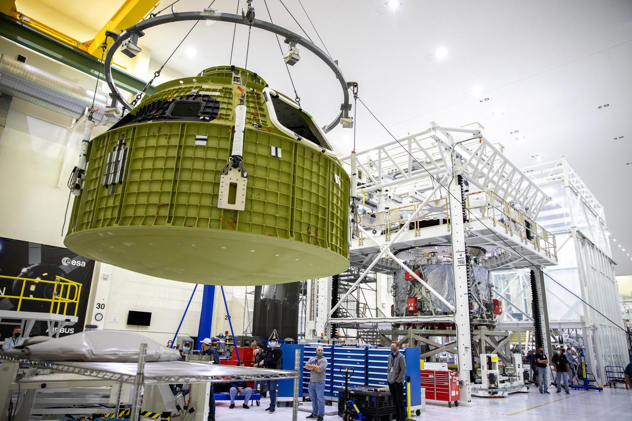 The Orion pressure vessel for NASA’s Artemis III mission is lifted by crane for its move onto a work stand  in the high bay of the Neil A. Armstrong Operations and Checkout Building at NASA’s Kennedy Space Center in Florida on Oct. 20, 2021. The pressure vessel will be secured onto the work stand where Lockheed Matin technicians will begin the work to prepare the spacecraft for its launch atop a Space Launch System rocket. Artemis III will send astronauts, including the first woman and first person of color, on a mission to the surface of the Moon by 2024. 