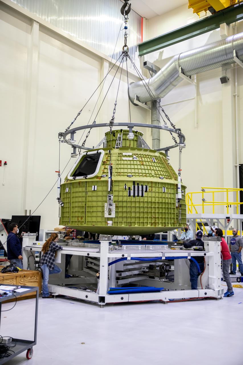 The Orion pressure vessel for NASA’s Artemis III mission is lowered onto a work stand in the high bay of the Neil A. Armstrong Operations and Checkout Building at NASA’s Kennedy Space Center in Florida on Oct. 20, 2021. Lockheed Matin technicians will begin the work to prepare the spacecraft for its launch atop a Space Launch System rocket. Artemis III will send astronauts, including the first woman and first person of color, on a mission to the surface of the Moon by 2024.