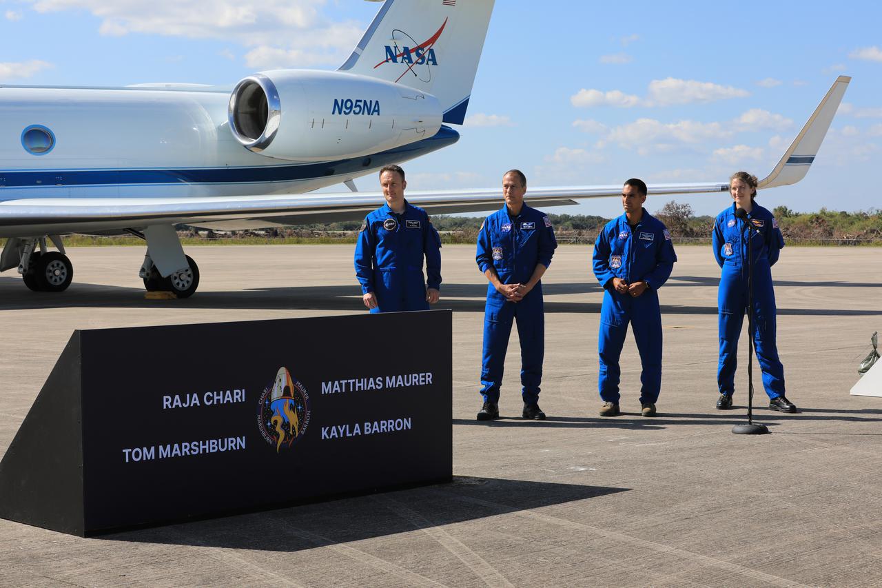 Crew members for NASA’s SpaceX Crew-3 mission to the International Space Station arrive at Kennedy Space Center’s Launch and Landing Facility in Florida on Oct. 26, 2021. From left, European Space Agency astronaut Matthias Maurer, and NASA astronauts Tom Marshburn, Raja Chari, and Kayla Barron speak to members of the news media. The crew will enter quarantine at the center’s Crew Quarters as they await launch aboard the Crew Dragon on a SpaceX Falcon 9 rocket. Launch is targeted for 2:21 a.m. EDT on Oct. 31 from Launch Complex 39A. Crew-3 is the third crew rotation flight for the agency’s Commercial Crew Program, and the first flight of a new Crew Dragon spacecraft.