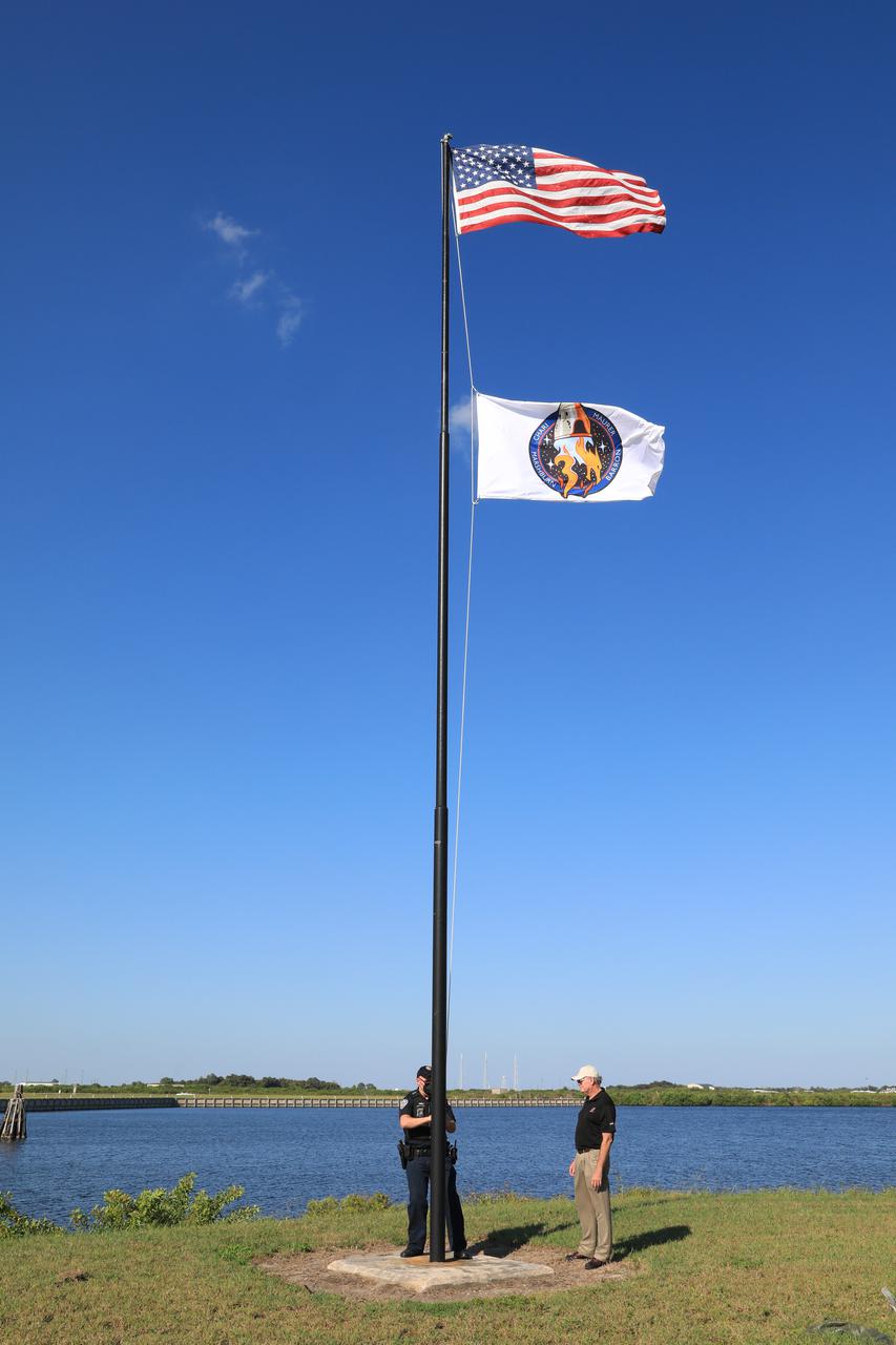 The SpaceX Crew-3 flag is raised below the American flag near the News Center countdown clock at NASA’s Kennedy Space Center in Florida on Oct. 26, 2021. The SpaceX Falcon 9 with Crew Dragon atop is scheduled to launch no earlier than Nov. 6, at 11:36 p.m. EDT from Launch Complex 39A at Kennedy. Crew Dragon will carry four astronauts to the International Space Station for NASA’s Commercial Crew Program. Crew-3 is the third crew rotation flight to the space station, and the first flight of a new Crew Dragon spacecraft. 