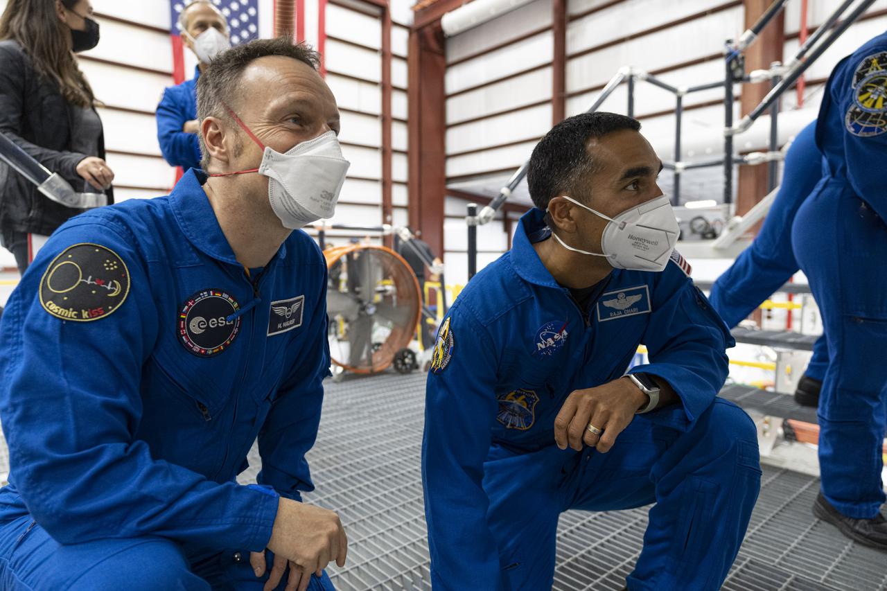 SpaceX Crew-3 astronaut Matthias Maurer, left, with the European Space Agency, and NASA astronaut Raja Chari, Crew-3 commander, are inside the SpaceX horizontal processing facility near Launch Complex 39A at Kennedy Space Center in Florida on Oct. 26, 2021. The astronauts are viewing the Falcon 9 rocket with Crew Dragon before rollout to the launch pad, which occurred on Oct. 27. The four-person crew will launch aboard the Crew Dragon atop the Falcon 9 on Oct. 31 to the International Space Station. Launch is targeted for 2:21 a.m. EDT from Pad 39A. Crew-3 is the third crew rotation flight to the space station for NASA’s Commercial Crew Program, and the first flight of a new Crew Dragon spacecraft.