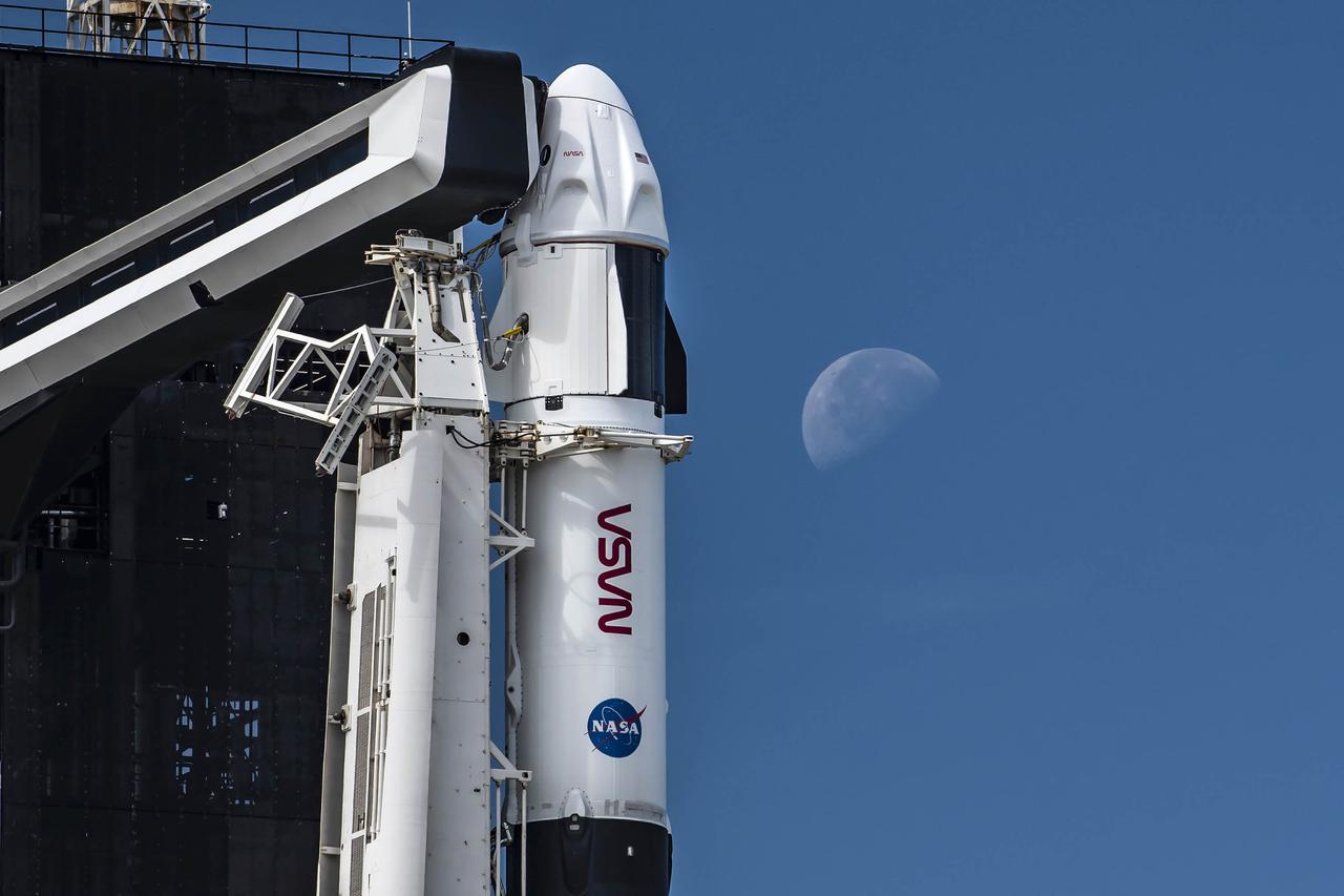 The SpaceX Falcon 9 rocket is vertical with the Crew Dragon atop for the Crew-3 mission at Launch Pad 39A at NASA’s Kennedy Space Center in Florida on Oct. 27, 2021. In view is the crew access arm. A four-person crew will launch aboard the Crew Dragon atop the Falcon 9 on Oct. 31 to the International Space Station. Launch is targeted for 2:21 a.m. EDT from Pad 39A. Crew 3 is the third crew rotation flight to the space station for NASA’s Commercial Crew Program, and the first flight of a new Crew Dragon spacecraft. 