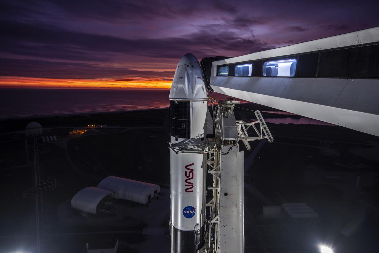 A close-up view of the SpaceX Falcon 9 rocket vertical with the Crew Dragon atop for the Crew-3 mission at Launch Pad 39A at NASA’s Kennedy Space Center in Florida during sunrise on Oct. 28, 2021. Also in view is the crew access arm. A four-person crew will launch aboard the Crew Dragon atop the Falcon 9 on Oct. 31 to the International Space Station. Launch is targeted for 2:21 a.m. EDT from Pad 39A. Crew 3 is the third crew rotation flight to the space station for NASA’s Commercial Crew Program, and the first flight of a new Crew Dragon spacecraft. 