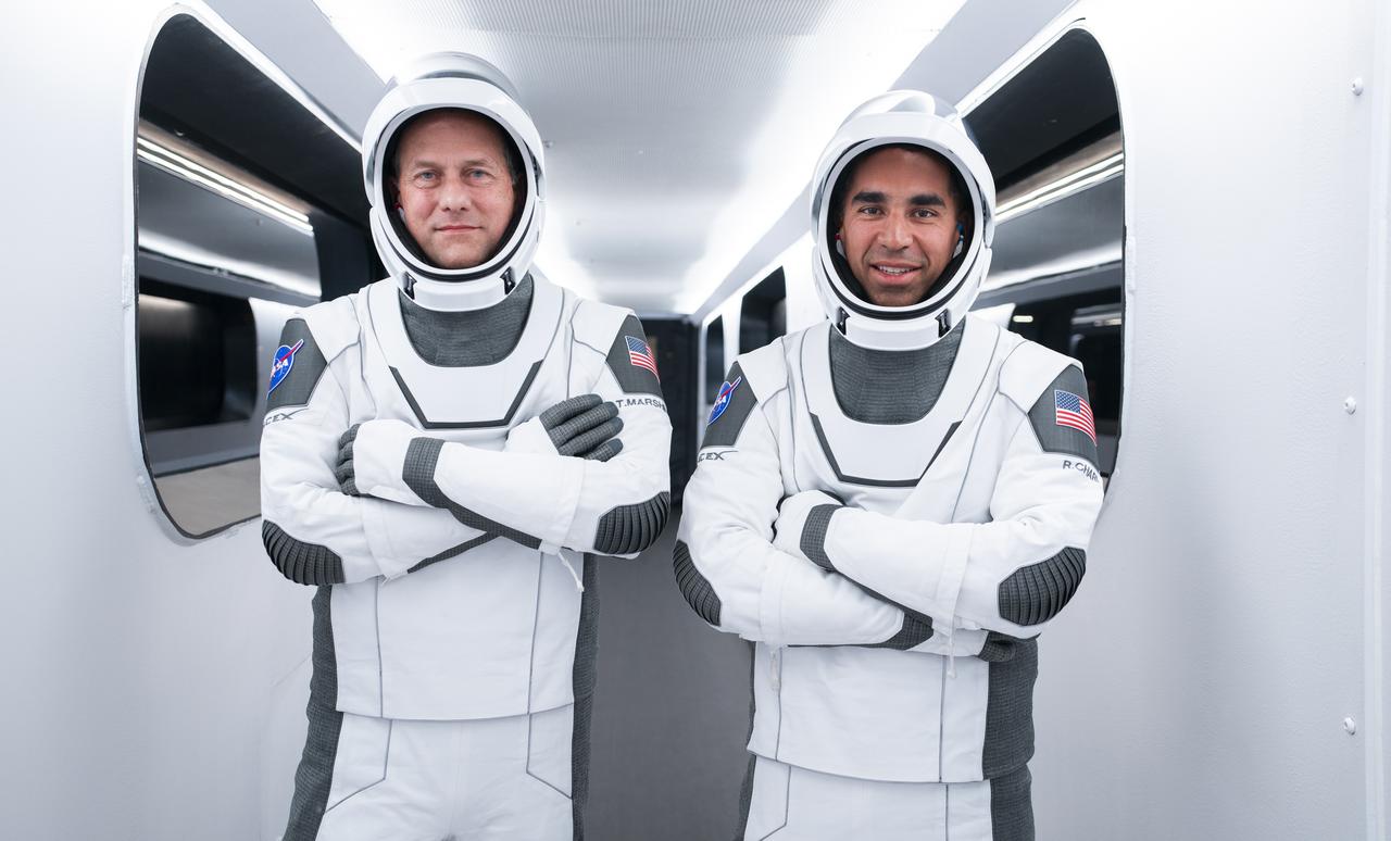 NASA’s SpaceX Crew-3 astronauts participate in a countdown dress rehearsal at the agency’s Kennedy Space Center in Florida on Oct. 28, 2021, to prepare for the upcoming Crew-3 launch. From left are NASA astronauts Tom Marshburn, pilot, and Raja Chari, Crew-3 commander. They are inside the crew access arm leading to the company’s Crew Dragon spacecraft during the rehearsal. The four-person crew will launch aboard the Crew Dragon atop the Falcon 9 on Oct. 31 to the International Space Station. Launch is targeted for 2:21 a.m. EDT from Pad 39A. Crew-3 is the third crew rotation flight to the space station for NASA’s Commercial Crew Program, and the first flight of a new Crew Dragon spacecraft. 