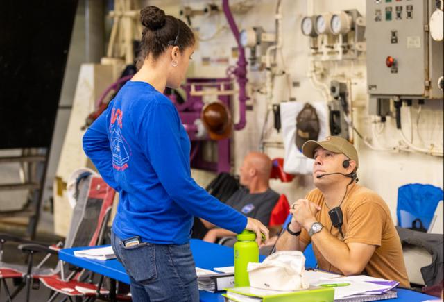 NASA Test Director (NTD) Christine St. Germain consults with fellow NTD Paul Sierpinski on day 2 of Underway Recovery Test 9 (URT-9) aboard the USS John P. Murtha. During the weeklong test, NASA’s Landing and Recovery team is performing their final mission certification ahead of Artemis I. 