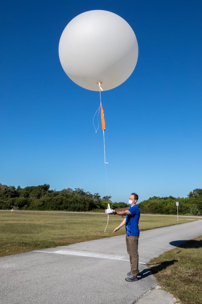 Meteorological Data Specialist Michael Boyer releases a weather balloon at the Cape Canaveral Space Force Station (CCSFS) Weather Station during an Artemis I weather simulation on Nov. 3, 2021. The event involved teams from CCSFS, Kennedy Space Center, Johnson Space Center in Texas, and Marshall Space Flight Center in Alabama. Weather balloons provided data below 6,000 feet and above 62,000 feet, while Kennedy’s Tropospheric Doppler Radar Wind Profiler delivered data from 6,000 to 62,000 feet. The radar wind profiler will be used as the primary upper level wind instrument for NASA’s Artemis missions, including Artemis I, the first launch of the agency’s Space Launch System rocket and the Orion spacecraft on a flight beyond the Moon.