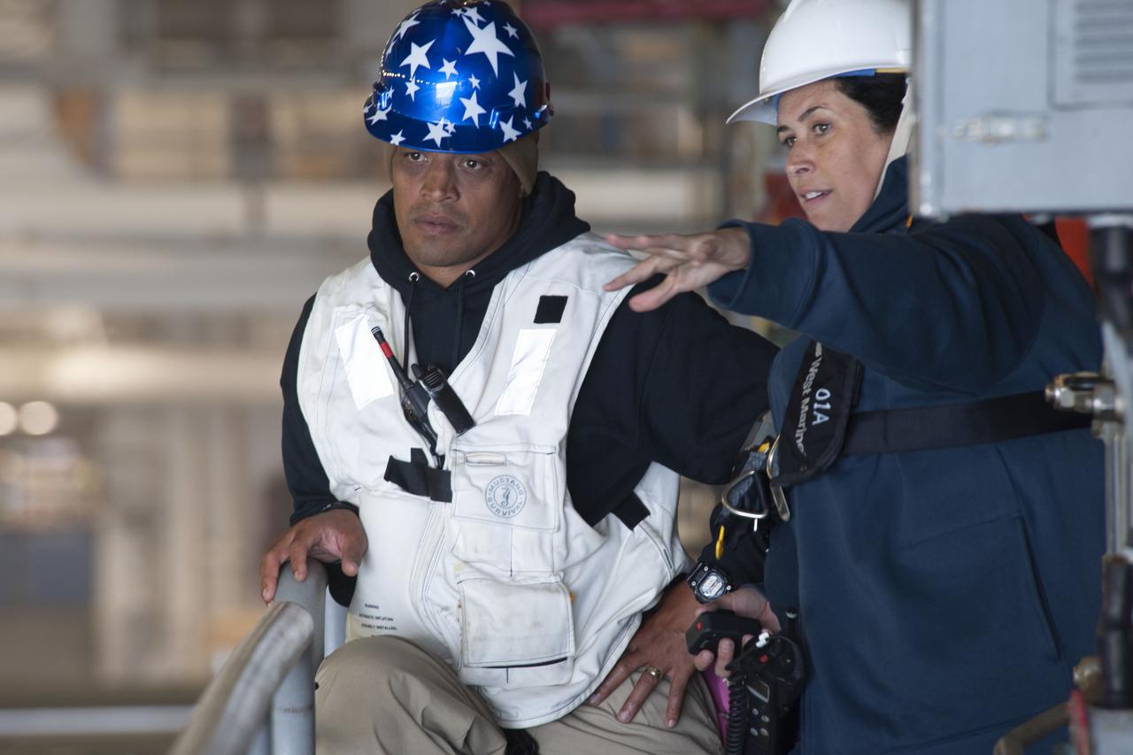 NASA Landing and Recovery Director Melissa Jones points out recovery operations to Capt. Gervy Alota, commanding officer, USS John P. Murtha (LPD 26), during Underway Recovery Test 9 (URT-9). During the weeklong test, NASA’s Landing and Recovery team is performing their final mission certification ahead of Artemis I.