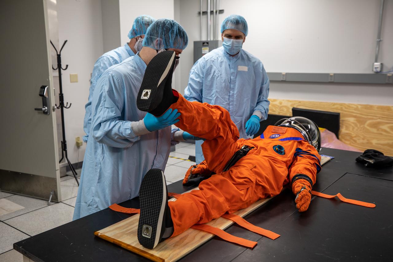Inside the Space Station Processing Facility at NASA’s Kennedy Space Center in Florida, teams from Johnson Space Center, Exploration Ground Systems, and Jacobs TOSC conduct final inspections of Moonikin “Campos” on Nov. 9, 2021, prior to installation into the Orion crew module. Technicians checked connectivity and performed fit checks on his flight suit to ensure he is ready for flight aboard the Artemis flight test. Artemis I will be an uncrewed test flight of the Orion spacecraft and Space Launch System rocket as an integrated system ahead of crewed flights to the Moon. Under Artemis, NASA aims to land the first woman and first person of color on the Moon and establish sustainable lunar exploration. 
