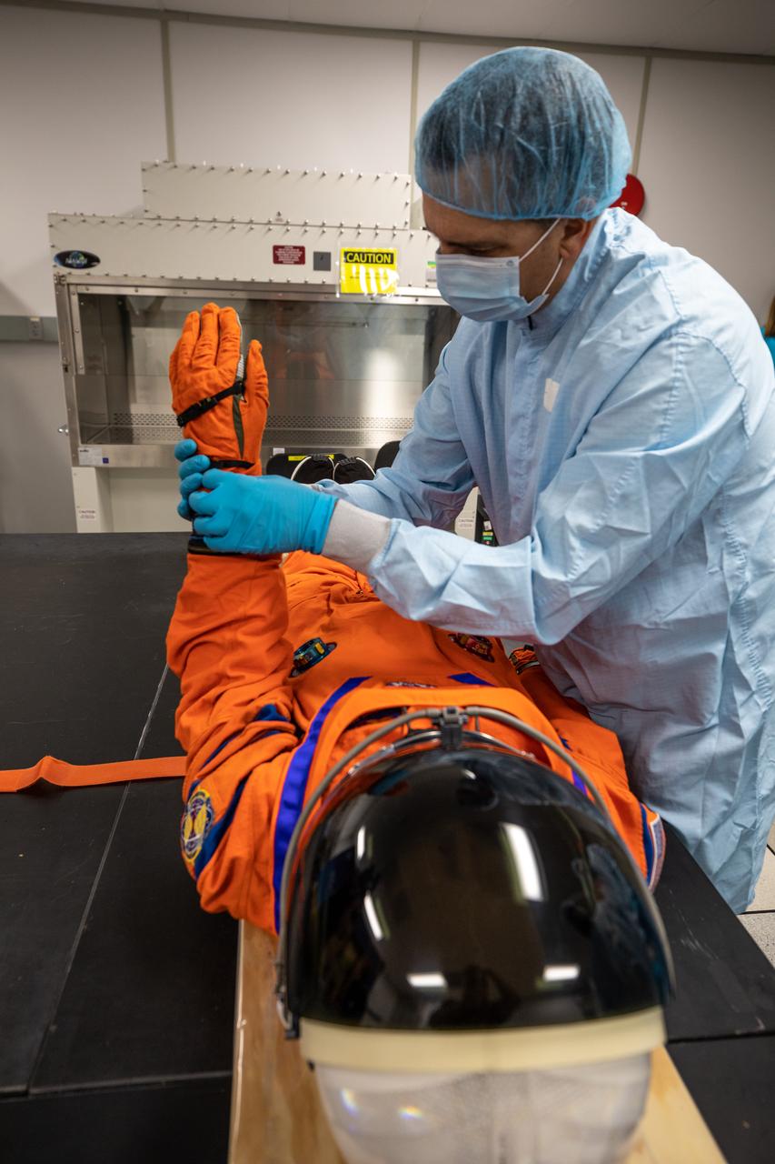 Inside the Space Station Processing Facility at NASA’s Kennedy Space Center in Florida, teams from Johnson Space Center, Exploration Ground Systems, and Jacobs TOSC conduct final inspections of Moonikin “Campos” on Nov. 9, 2021, prior to installation into the Orion crew module. Technicians checked connectivity and performed fit checks on his flight suit to ensure he is ready for flight aboard the Artemis flight test. Artemis I will be an uncrewed test flight of the Orion spacecraft and Space Launch System rocket as an integrated system ahead of crewed flights to the Moon. Under Artemis, NASA aims to land the first woman and first person of color on the Moon and establish sustainable lunar exploration. 