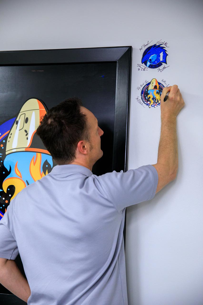 Matthias Maurer, ESA (European Space Agency) astronaut and mission specialist for the SpaceX Crew-3 mission, signs the mission patch on the wall in the Astronaut Crew Quarters inside the Neil Armstrong Operations and Checkout Building at NASA’s Kennedy Space Center in Florida on Nov. 10, 2021. The Falcon 9 rocket with Crew Dragon Endurance will launch the four-person crew to the International Space Station for NASA’s Commercial Crew Program. Crew-3 is scheduled to launch Nov. 10 at 9:03 p.m. EST from Launch Complex 39A at Kennedy. 