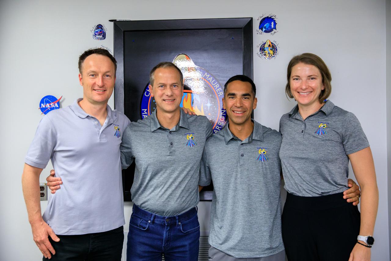 The SpaceX Crew-3 astronauts stand together in the hallway of the Astronaut Crew Quarters inside the Neil Armstrong Operations and Checkout Building at NASA’s Kennedy Space Center in Florida on Nov. 10, 2021. They have just signed the Crew-3 mission patch on the wall behind them. From left are Matthias Maurer, ESA (European Space Agency) astronaut and mission specialist; and NASA astronauts Tom Marshburn, pilot; Raja Chari, commander; and Kayla Barron, mission specialist. The Falcon 9 rocket with Crew Dragon Endurance will launch the four-person crew to the International Space Station for NASA’s Commercial Crew Program. Crew-3 is scheduled to launch Nov. 10 at 9:03 p.m. EST from Launch Complex 39A at Kennedy. 
