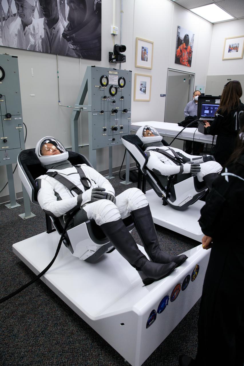 NASA SpaceX Crew-3 mission astronauts are in the suit-up room in the Astronaut Crew Quarters inside Kennedy Space Center’s Neil A. Armstrong Operations and Checkout Building on launch day, Nov. 10, 2021. A team of SpaceX suit technicians will help them as they put on their custom-fitted spacesuits and check the suits for leaks. In view, from left are NASA astronauts Tom Marshburn, pilot; and Raja Chari, commander. The Falcon 9 rocket with Crew Dragon Endurance will launch the four-person crew to the International Space Station for NASA’s Commercial Crew Program. Crew-3 is scheduled to launch at 9:03 p.m. EST from Launch Complex 39A at Kennedy. 