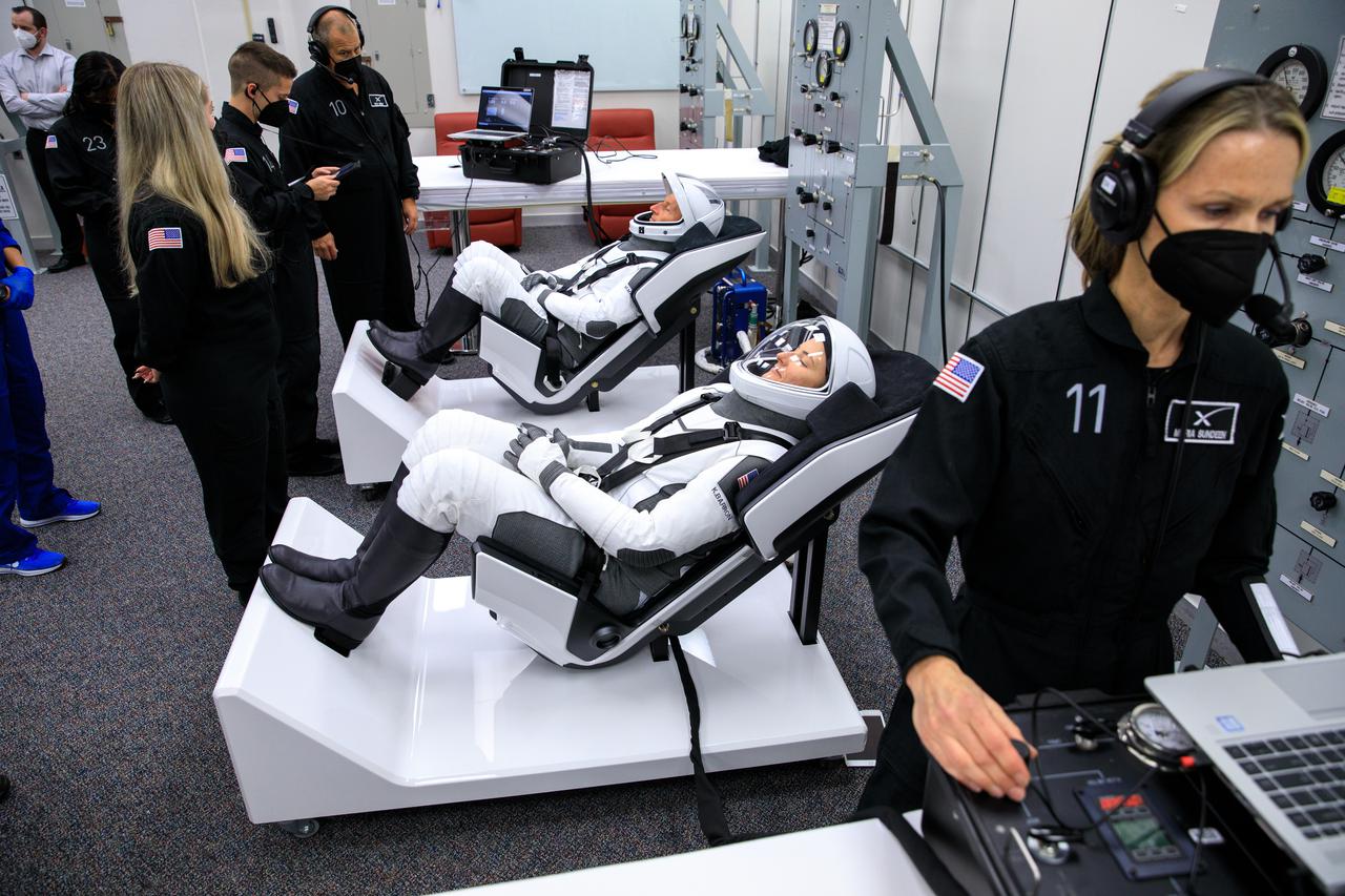 NASA SpaceX Crew-3 mission astronauts are in the suit-up room in the Astronaut Crew Quarters inside Kennedy Space Center’s Neil A. Armstrong Operations and Checkout Building on launch day, Nov. 10, 2021. A team of SpaceX suit technicians assist the astronauts with their custom-fitted spacesuits, checking them for leaks. The Falcon 9 rocket with Crew Dragon Endurance will launch the four-person crew to the International Space Station for NASA’s Commercial Crew Program. Crew-3 is scheduled to launch at 9:03 p.m. EST from Launch Complex 39A at Kennedy.