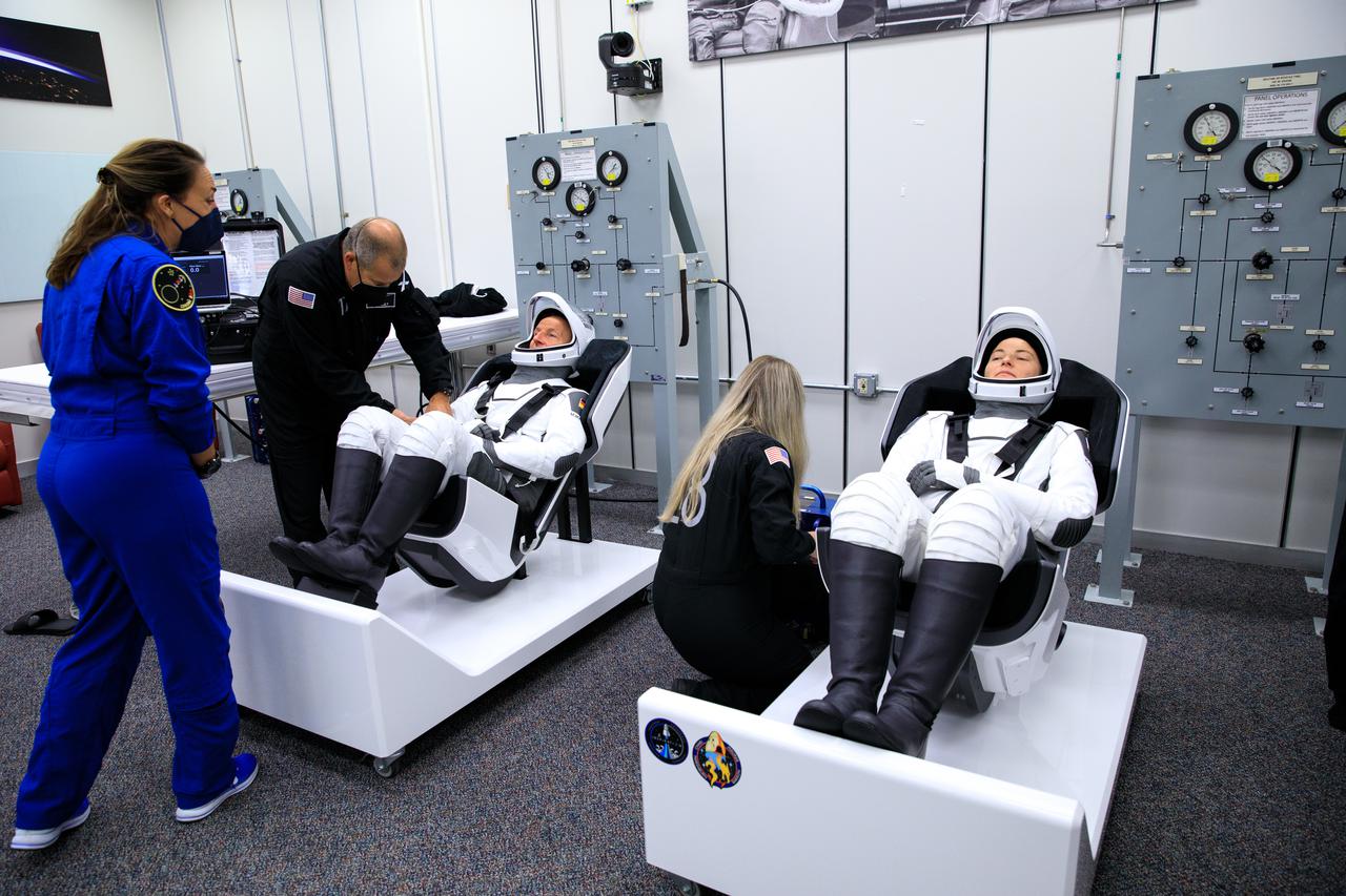 NASA SpaceX Crew-3 mission astronauts are in the suit-up room in the Astronaut Crew Quarters inside Kennedy Space Center’s Neil A. Armstrong Operations and Checkout Building on launch day, Nov. 10, 2021. A team of SpaceX suit technicians assist the astronauts with their custom-fitted spacesuits, checking them for leaks. The Falcon 9 rocket with Crew Dragon Endurance will launch the four-person crew to the International Space Station for NASA’s Commercial Crew Program. Crew-3 is scheduled to launch at 9:03 p.m. EST from Launch Complex 39A at Kennedy.
