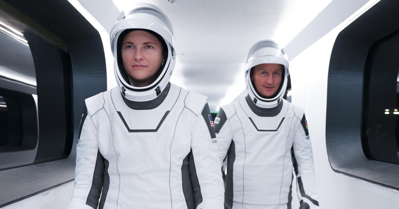 The SpaceX Crew-3 astronauts walk across the crew access arm to the Crew Dragon atop the SpaceX Falcon 9 rocket at Launch Complex 39A at NASA’s Kennedy Space Center in Florida on Nov. 10, 2021. In view from left are NASA astronaut Kayla Barron, mission specialist, and Matthias Maurer, ESA (European Space Agency) astronaut and mission specialist. The Falcon 9 rocket with Crew Dragon Endurance will launch the four-person crew to the International Space Station for the agency’s Commercial Crew Program. Crew-3 is scheduled to launch at 9:03 p.m. EST from historic Launch Pad 39A at Kennedy. 