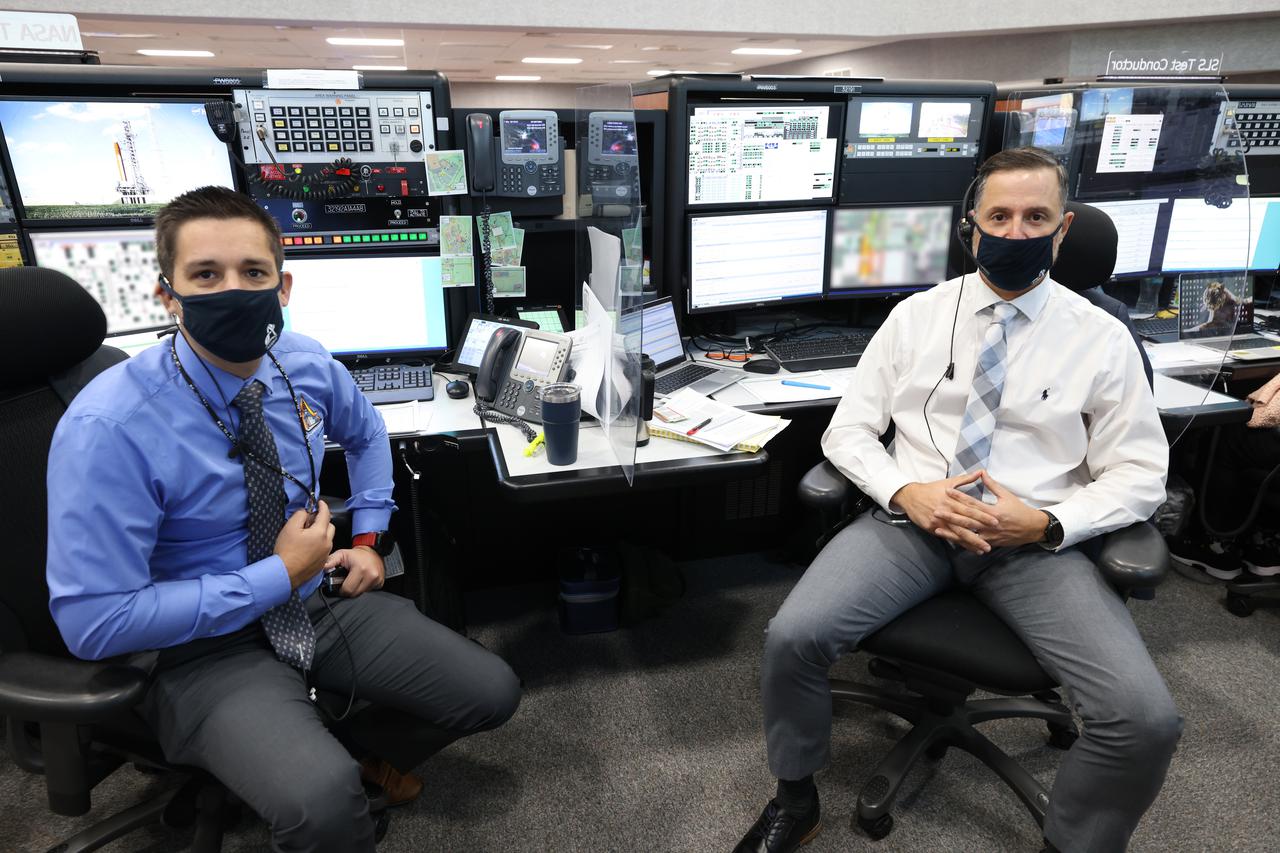 NASA Test Directors Daniel Florez, left, and Carlos Monje, right, with Exploration Ground Systems, are seated at their consoles inside Firing Room 1 of the Launch Control Center at NASA’s Kennedy Space Center in Florida on Dec. 13, 2021. They are participating in a joint integrated simulation for the Artemis I launch that covered both cryogenic loading and terminal countdown portions of prelaunch activities. Members of NASA’s mission management team and launch team conducted the simulation together. The Kennedy team was certified for the Artemis I launch. During Artemis I, the agency’s Orion spacecraft will lift off from Kennedy aboard NASA’s most powerful rocket – the Space Launch System – to fly farther than any spacecraft built for humans has ever flown. Through NASA’s Artemis missions, the agency, along with commercial and international partners, will establish a sustainable human presence on the Moon to prepare for missions to Mars. 