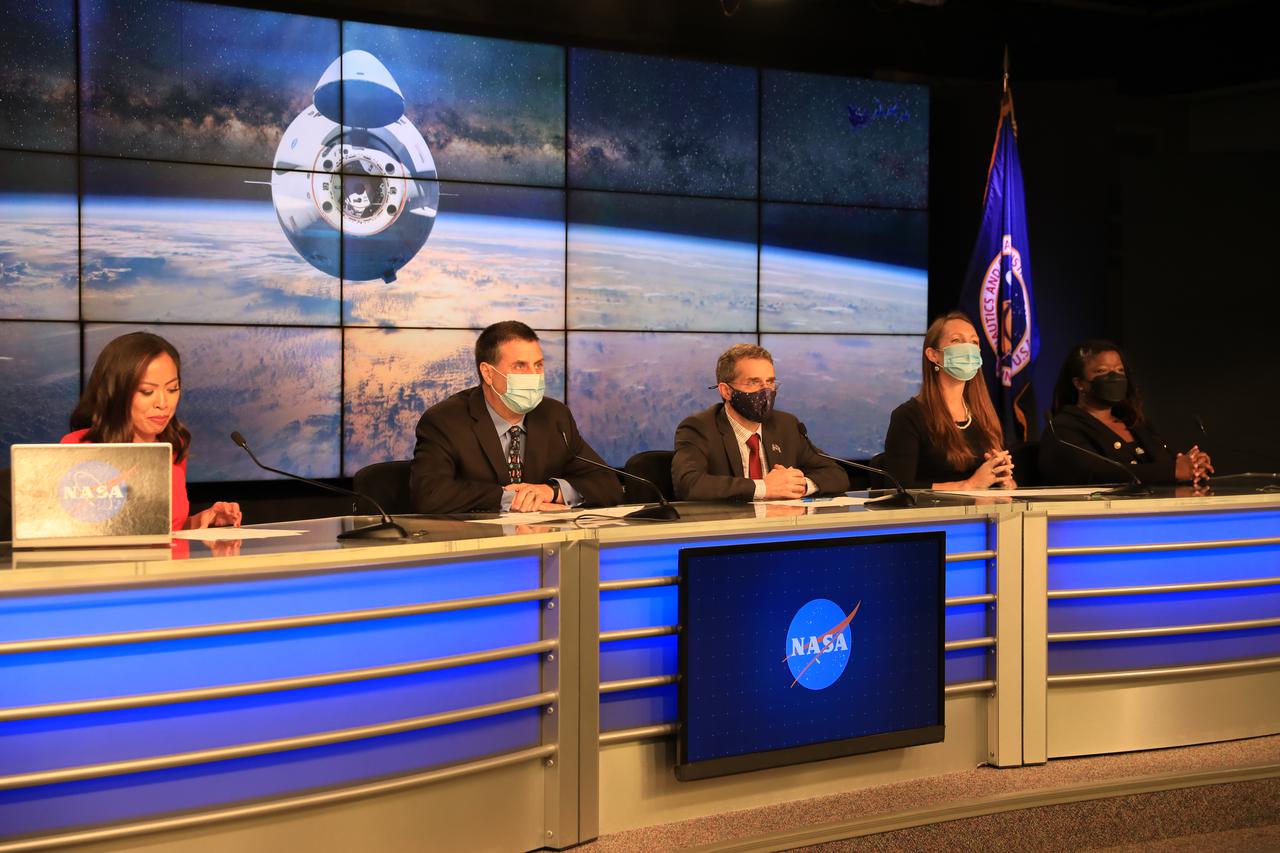 From left, Megan Cruz, NASA Communications; Joel Montalbano, manager, International Space Station Program; Dr. Bob Dempsey, acting deputy chief scientist, International Space Station Program; Sarah Walker, director, Dragon mission management, SpaceX; and Arlena Moses, launch weather officer, 45th Weather Squadron, Cape Canaveral Space Force Station, participate in NASA’s SpaceX 24th commercial resupply services mission prelaunch news conference at Kennedy Space Center in Florida on Tuesday, Dec. 20, 2021. Liftoff of the SpaceX Falcon 9 rocket with the company’s Dragon spacecraft on board is targeted for Tuesday, Dec. 21, 2021, at 5:07 a.m. EST. The mission will deliver new science investigations, supplies, and equipment to the crew on board the International Space Station.