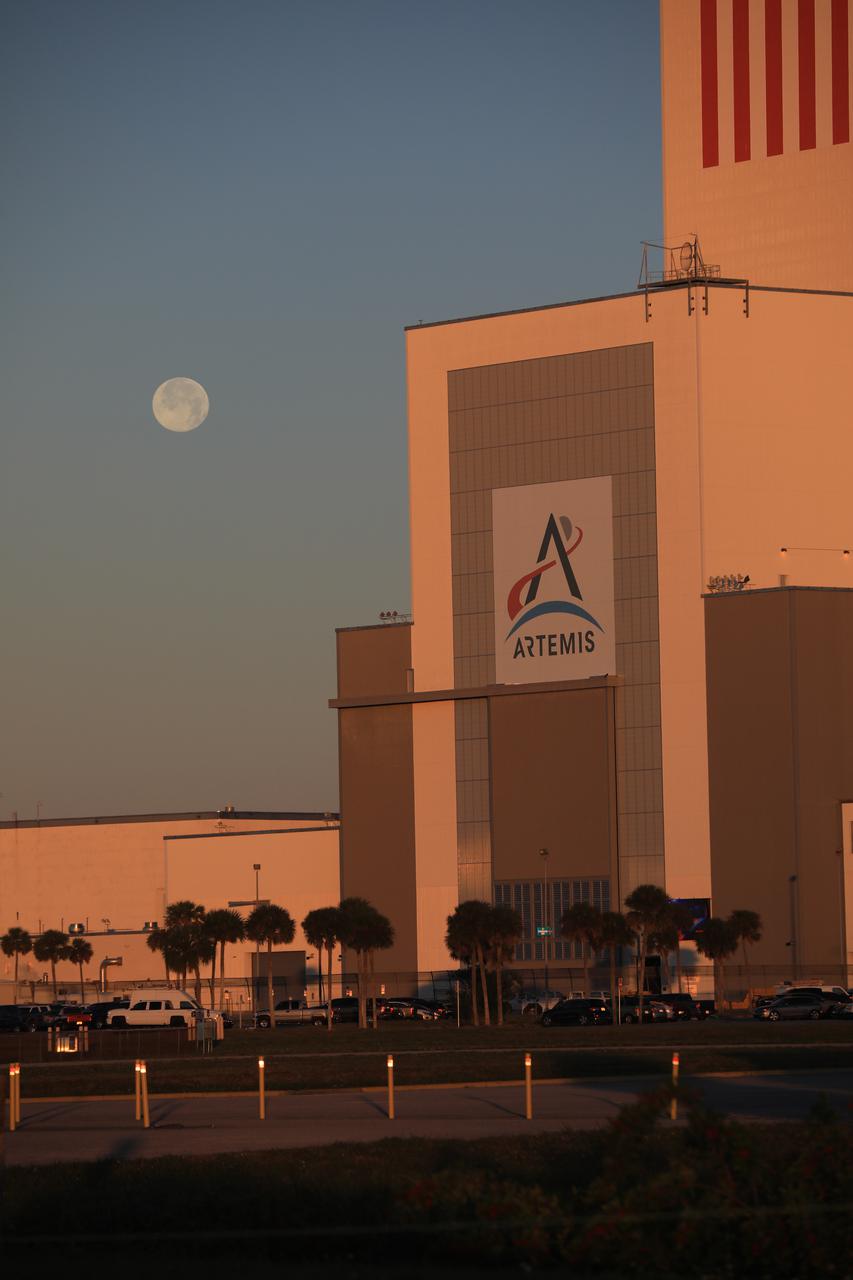 A brilliant Moon serves as the backdrop in this view of the low bay entrance to the Vehicle Assembly Building at NASA’s Kennedy Space Center in Florida on Jan. 18, 2020. An Artemis banner is positioned over the entrance.