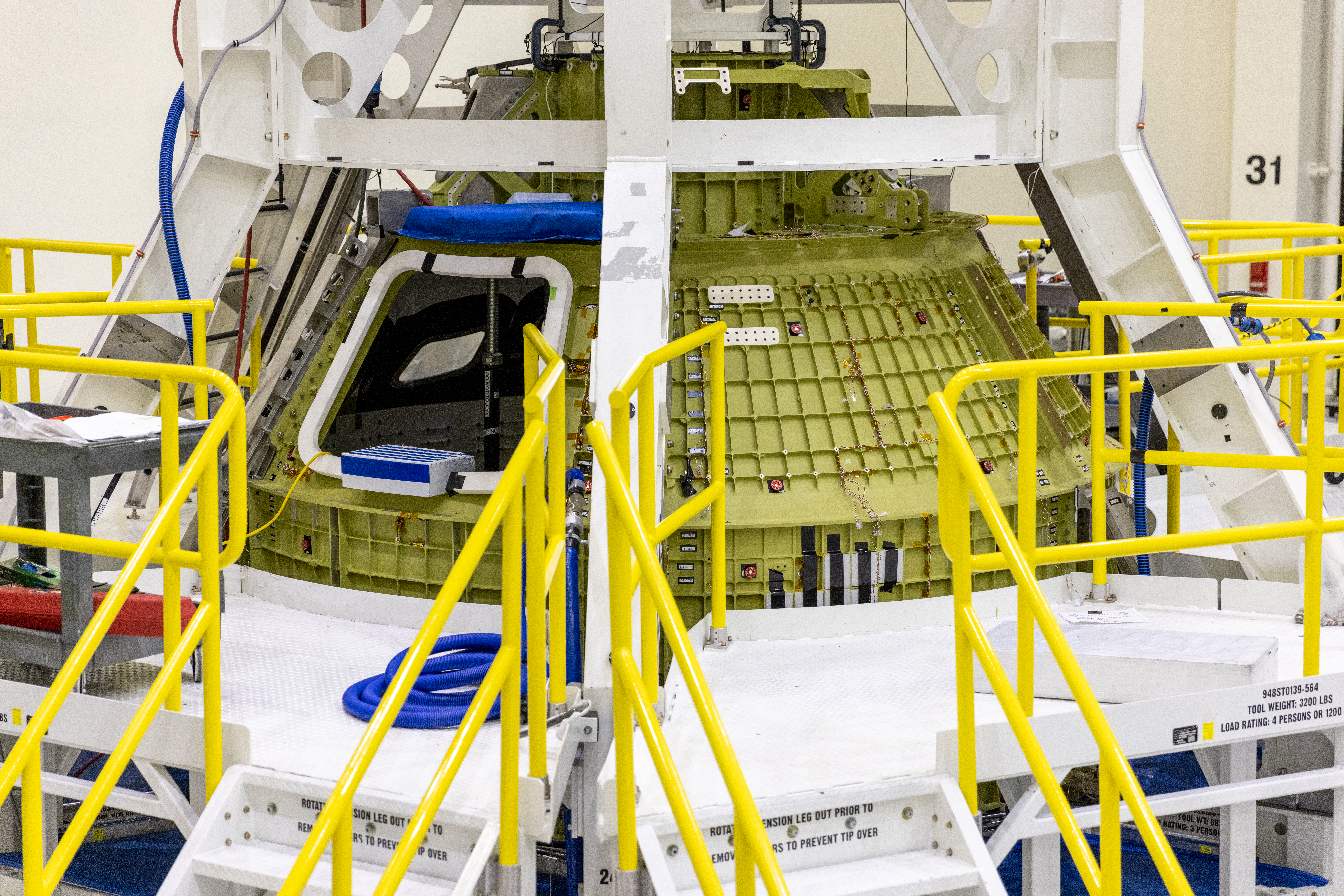 A close-up view of the Orion crew module for NASA’s Artemis III mission enclosed on a work stand inside the high bay of the Neil A. Armstrong Operations and Checkout Building at NASA’s Kennedy Space Center in Florida on Jan. 20, 2022. Lockheed Martin technicians are processing and preparing the crew module for its launch atop the Space Launch System rocket. Launched atop the Space Launch System rocket, Artemis missions  will aim to send astronauts, including the first woman and first person of color, on a mission to the surface of the Moon. 