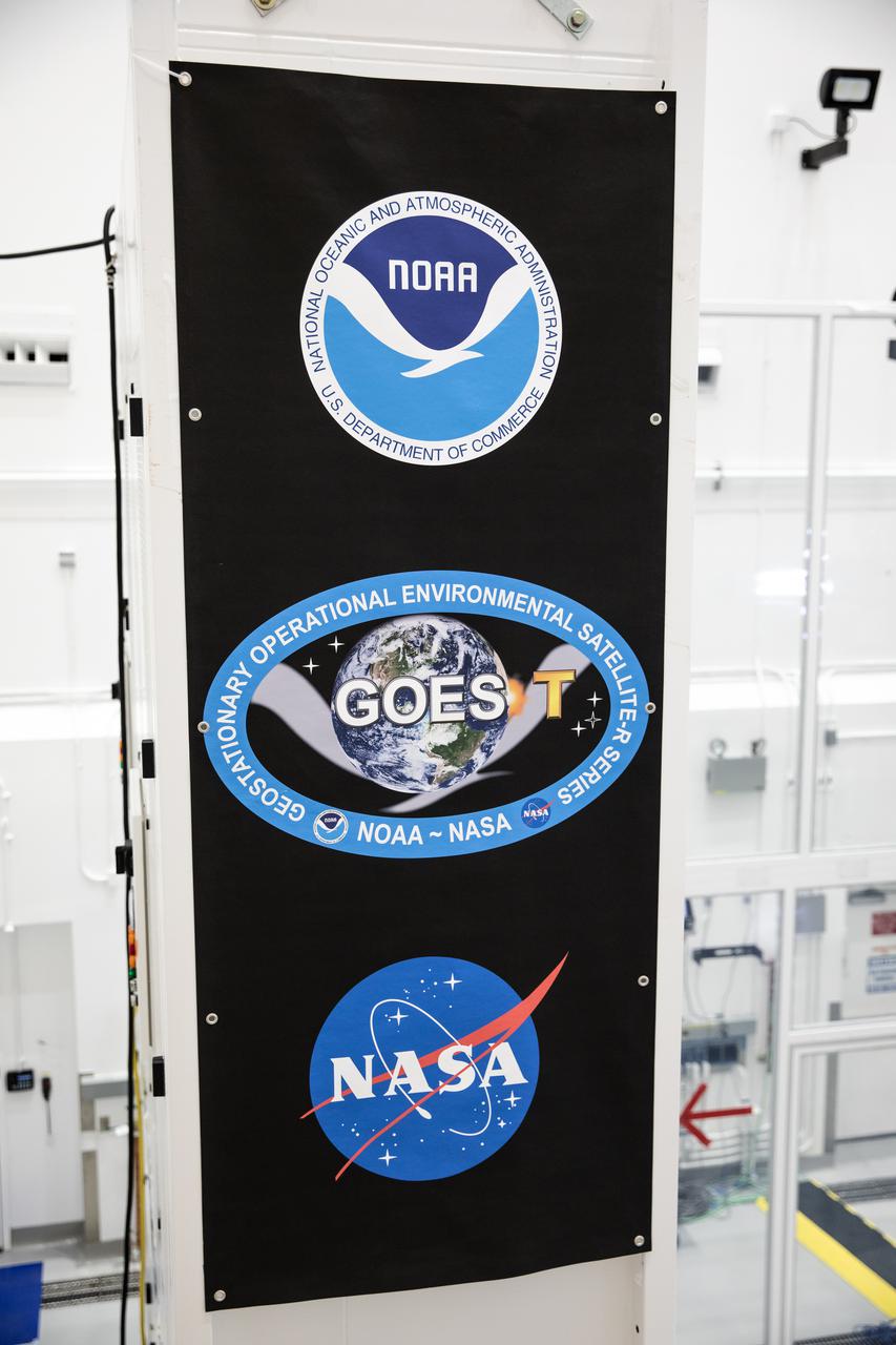A banner for NOAA’s Geostationary Operational Environmental Satellite-T (GOES-T) is in view inside the Astrotech Space Operations facility in Titusville, Florida, on Jan. 20, 2022. GOES-T is scheduled to launch on March 1, 2022, atop a United Launch Alliance (ULA) Atlas V 541 rocket from Space Launch Complex 41 at Cape Canaveral Space Force Station. GOES-T is the third satellite in the GOES-R series that will continue to help meteorologists observe and predict local weather events that affect public safety. The launch is being managed by NASA’s Launch Services Program based at Kennedy Space Center in Florida, America’s multi-user spaceport. 