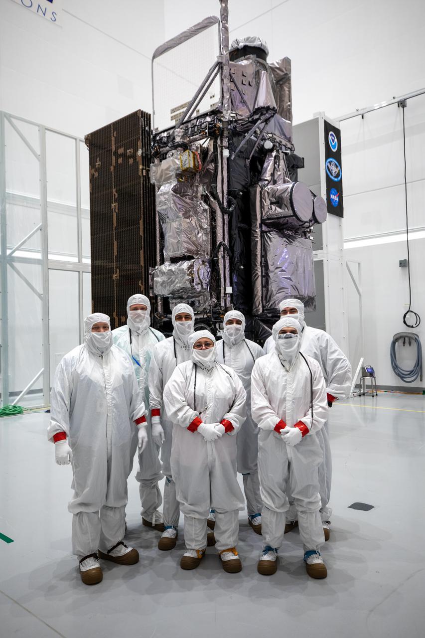 Dressed in clean-room suits, processing team members stand in front of NOAA’s Geostationary Operational Environmental Satellite-T (GOES-T) inside the Astrotech Space Operations facility in Titusville, Florida, on Jan. 20, 2022. GOES-T is scheduled to launch on March 1, 2022, atop a United Launch Alliance (ULA) Atlas V 541 rocket from Space Launch Complex 41 at Cape Canaveral Space Force Station. GOES-T is the third satellite in the GOES-R series that will continue to help meteorologists observe and predict local weather events that affect public safety. The launch is being managed by NASA’s Launch Services Program based at Kennedy Space Center in Florida, America’s multi-user spaceport. 