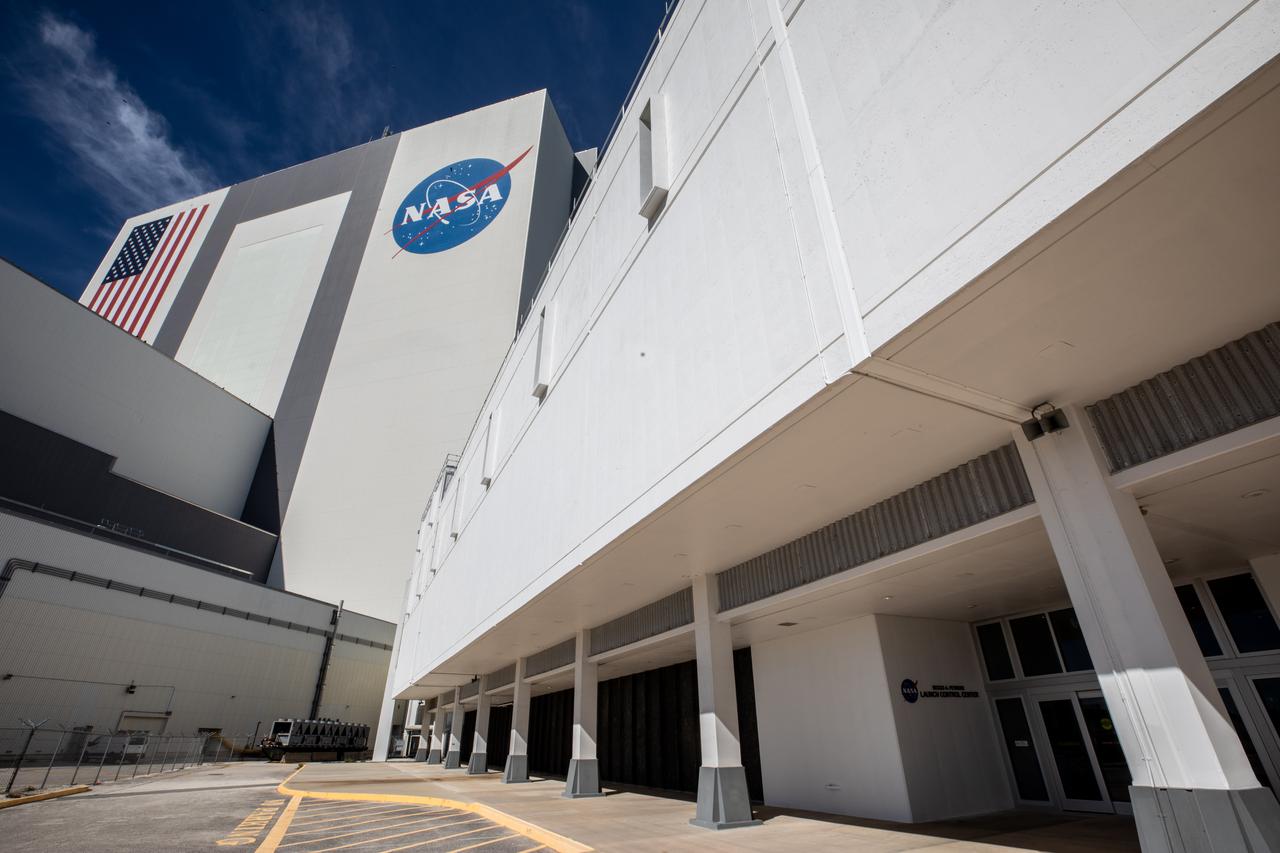 Following a ceremony at NASA’s Kennedy Space Center, the Florida spaceport’s launch control center (foreground) was officially renamed the Rocco A. Petrone Launch Control Center. In the background is Kennedy’s historic Vehicle Assembly Building. The newly named facility serves as a nerve center where engineers and the launch director will monitor their flight consoles and give the “go” for the upcoming launch of Artemis I and later missions that will establish a sustainable presence on the Moon to prepare for missions to Mars. Petrone, who was instrumental in America’s first voyages to the Moon and headed the Apollo program, died in 2006 at the age of 80.