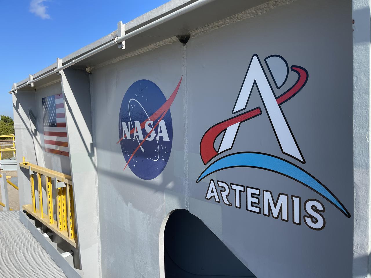 Eight new NASA Artemis logos (four large, four small) were installed on Crawler-Transporter 2 at Kennedy Space Center in preparation for the upcoming launch of Artemis I. Named after the twin sister of Apollo, Artemis is the Goddess of the Moon. The Artemis missions will take humanity back to the Moon and beyond, beginning a new legacy of deep space exploration.