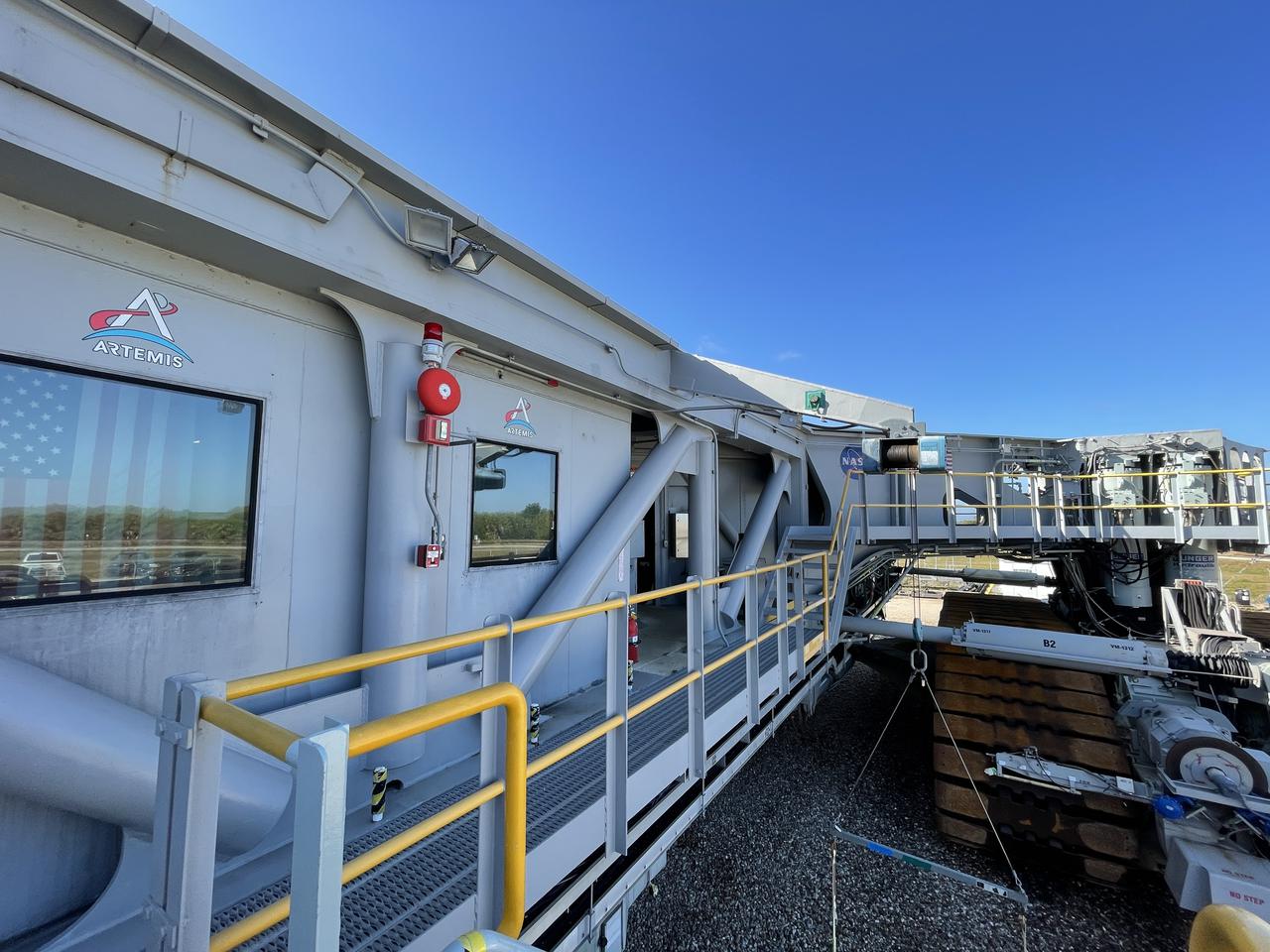 Eight new NASA Artemis logos (four large, four small) were installed on Crawler-Transporter 2 at Kennedy Space Center in preparation for the upcoming launch of Artemis I. Named after the twin sister of Apollo, Artemis is the Goddess of the Moon. The Artemis missions will take humanity back to the Moon and beyond, beginning a new legacy of deep space exploration.