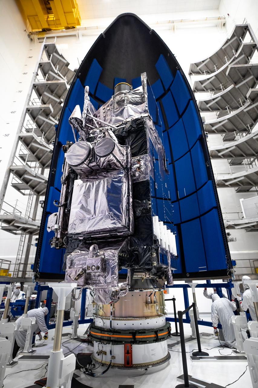 The first half of the United Launch Alliance Atlas V payload fairing is being secured around NOAA’s Geostationary Operational Environmental Satellite-T (GOES-T) inside the Astrotech Space Operations facility in Titusville, Florida, on Feb. 7, 2022. The satellite will be encapsulated inside the payload fairings, which will protect it during launch. GOES-T is scheduled to launch on March 1, 2022, atop Atlas V 541 rocket from Space Launch Complex 41 at Cape Canaveral Space Force Station. GOES-T is the third satellite in the GOES-R series that will continue to help meteorologists observe and predict local weather events that affect public safety. The launch is being managed by NASA’s Launch Services Program based at Kennedy Space Center in Florida, America’s multi-user spaceport.