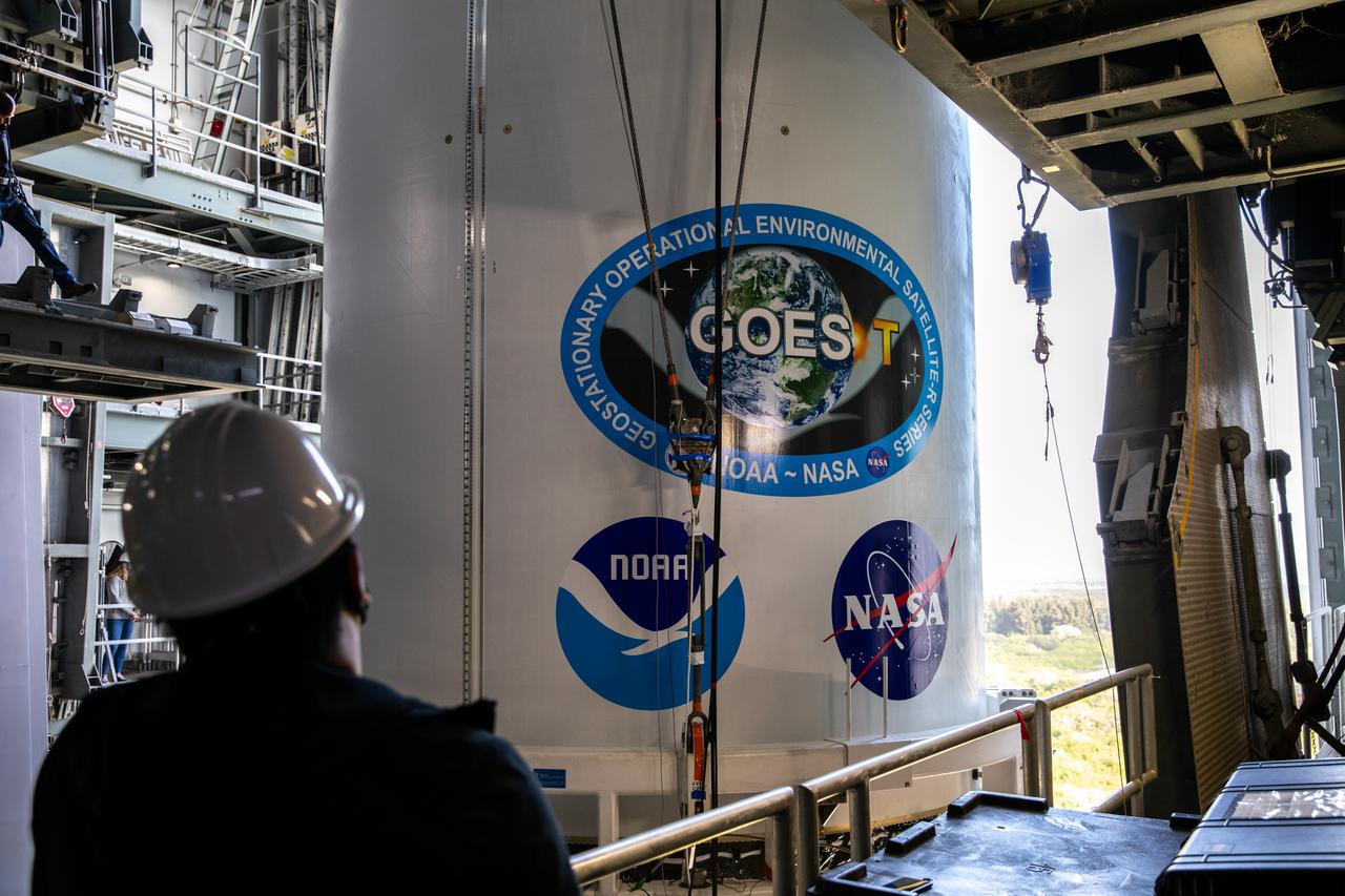 A United Launch Alliance technician monitors the progress as the National Oceanic and Atmospheric Administration’s (NOAA) Geostationary Operational Environmental Satellite-T (GOES-T), enclosed in its payload fairing, is moved into the Vertical Integration Facility at Space Launch Complex 41 at Cape Canaveral Space Force Station in Florida on Feb. 17, 2022. The satellite will be secured atop the United Launch Alliance Atlas V 541 rocket. GOES-T is scheduled to launch atop the Atlas V rocket from SLC-41 on March 1, 2022, at 4:38 p.m. GOES-T is the third satellite in the GOES-R series that will continue to help meteorologists observe and predict local weather events that affect public safety. The launch is being managed by NASA’s Launch Services Program based at Kennedy Space Center in Florida, America’s multi-user spaceport.