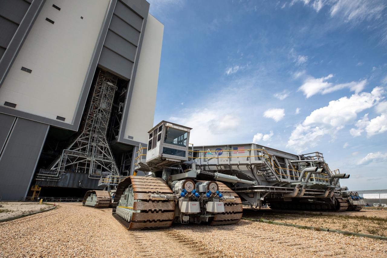 The crawler-transporter 2, driven by engineers and technicians, approaches the Vehicle Assembly Building (VAB) at NASA’s Kennedy Space Center in Florida on March 11, 2022. The crawler will go inside the VAB, where it will slide under the Artemis I Space Launch System with the Orion spacecraft atop on the mobile launcher and carry it to Launch Complex 39B for a wet dress rehearsal test ahead of the Artemis I launch. Artemis I will be the first integrated test of the SLS and Orion spacecraft. In later missions, NASA will land the first woman and the first person of color on the surface of the Moon, paving the way for a long-term lunar presence and serving as a steppingstone on the way to Mars