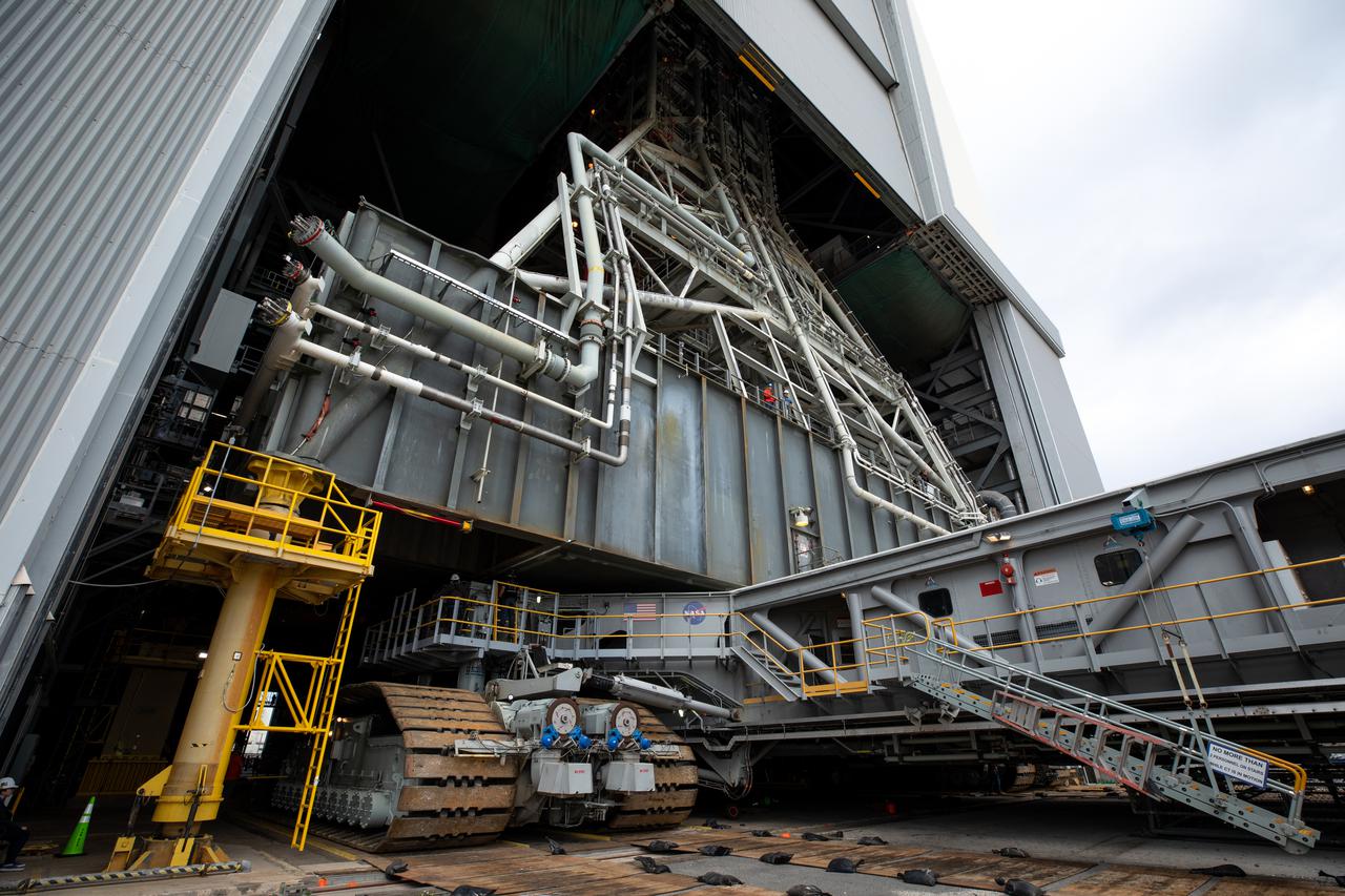Engineers and technicians drive the crawler-transporter 2 under the Artemis I Space Launch System (SLS) with the Orion spacecraft atop on the mobile launcher inside the Vehicle Assembly Building at NASA’s Kennedy Space Center in Florida on March 15, 2022. The crawler will carry the Artemis I stack to Launch Complex 39B for a wet dress rehearsal test ahead of launch. Artemis I will be the first integrated test of the SLS and Orion spacecraft. In later missions, NASA will land the first woman and the first person of color on the surface of the Moon, paving the way for a long-term lunar presence and serving as a steppingstone on the way to Mars. 