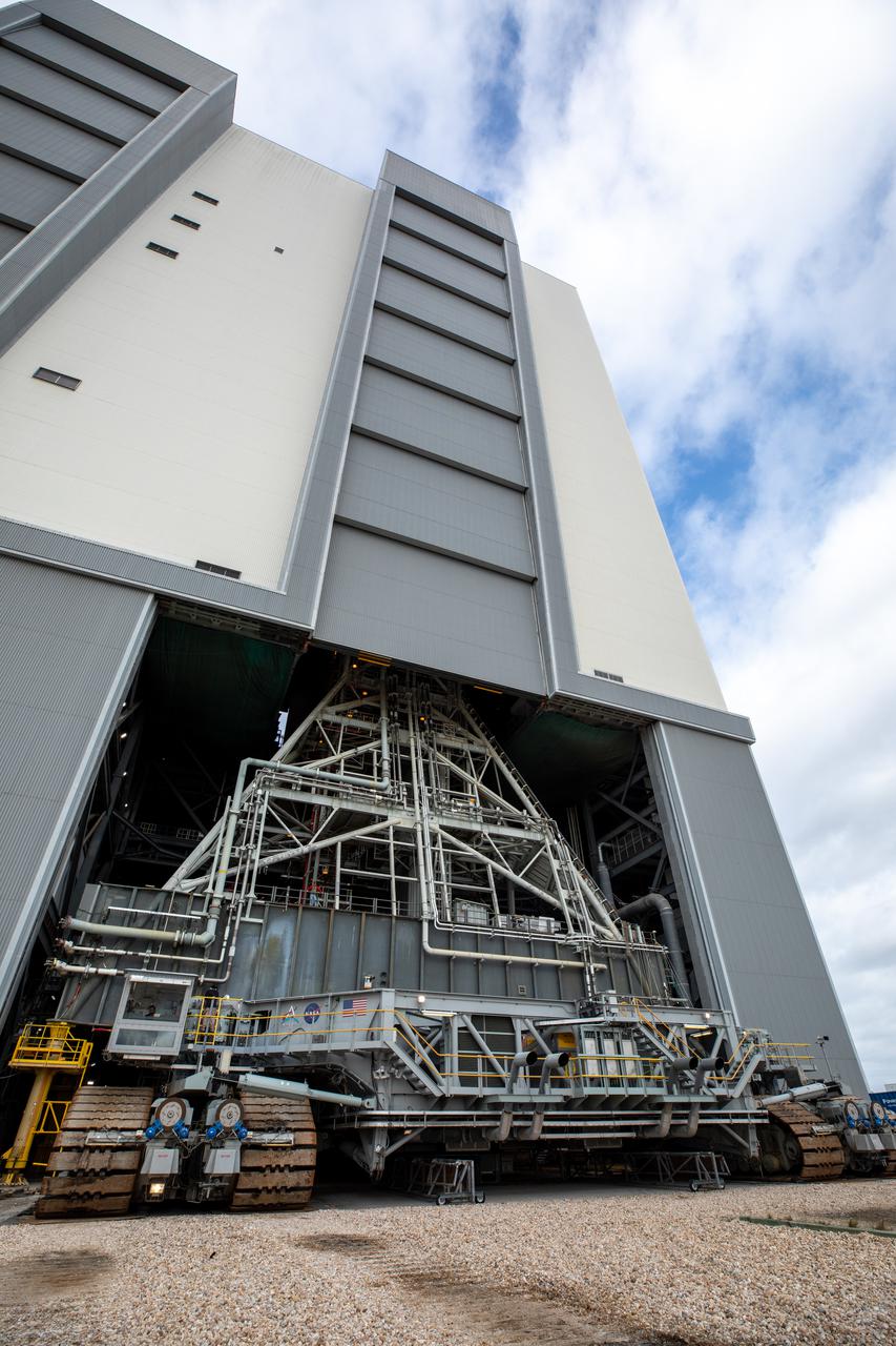 Engineers and technicians drive the crawler-transporter 2 under the Artemis I Space Launch System (SLS) with the Orion spacecraft atop on the mobile launcher inside the Vehicle Assembly Building at NASA’s Kennedy Space Center in Florida on March 15, 2022. The crawler will carry the Artemis I stack to Launch Complex 39B for a wet dress rehearsal test ahead of launch. Artemis I will be the first integrated test of the SLS and Orion spacecraft. In later missions, NASA will land the first woman and the first person of color on the surface of the Moon, paving the way for a long-term lunar presence and serving as a steppingstone on the way to Mars. 