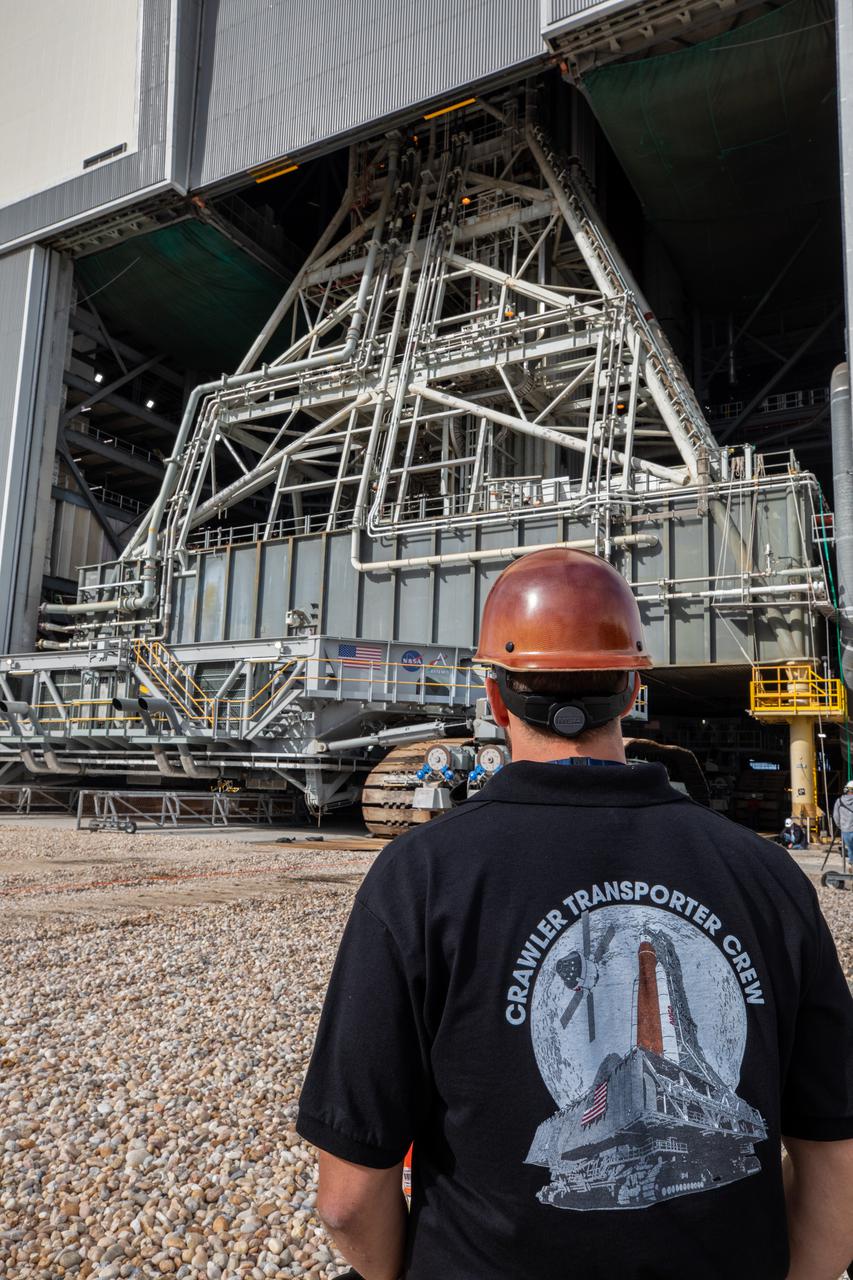 Driven by engineers and technicians, the crawler-transporter 2, slides under the Artemis I Space Launch System (SLS) with the Orion spacecraft atop on the mobile launcher inside the Vehicle Assembly Building at NASA’s Kennedy Space Center in Florida on March 15, 2022. The crawler will carry the Artemis I stack to Launch Complex 39B for a wet dress rehearsal test ahead of launch. Artemis I will be the first integrated test of the SLS and Orion spacecraft. In later missions, NASA will land the first woman and the first person of color on the surface of the Moon, paving the way for a long-term lunar presence and serving as a steppingstone on the way to Mars. 