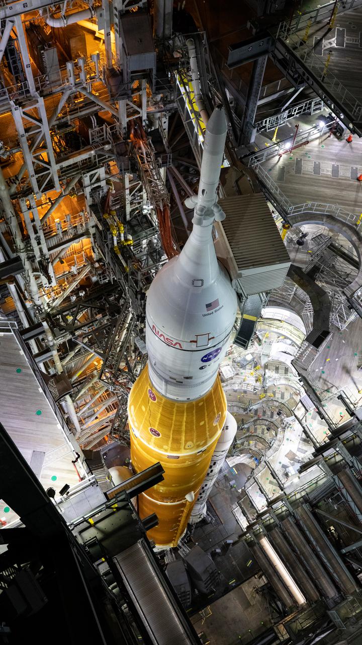 In this view looking down in High Bay 3 of the Vehicle Assembly Building at NASA’s Kennedy Space Center in Florida, all of the work platforms that surround the Artemis I Space Launch System (SLS) and Orion spacecraft are fully retracted on March 16, 2022. The Artemis I stack atop the mobile launcher will roll out to Launch Complex 39B atop the crawler-transporter 2 for a wet dress rehearsal ahead of launch. Artemis I will be the first integrated test of the SLS and Orion spacecraft. In later missions, NASA will land the first woman the first person of color on the surface of the Moon, paving the way for a long-term lunar presence and serving as a steppingstone on the way to Mars.
