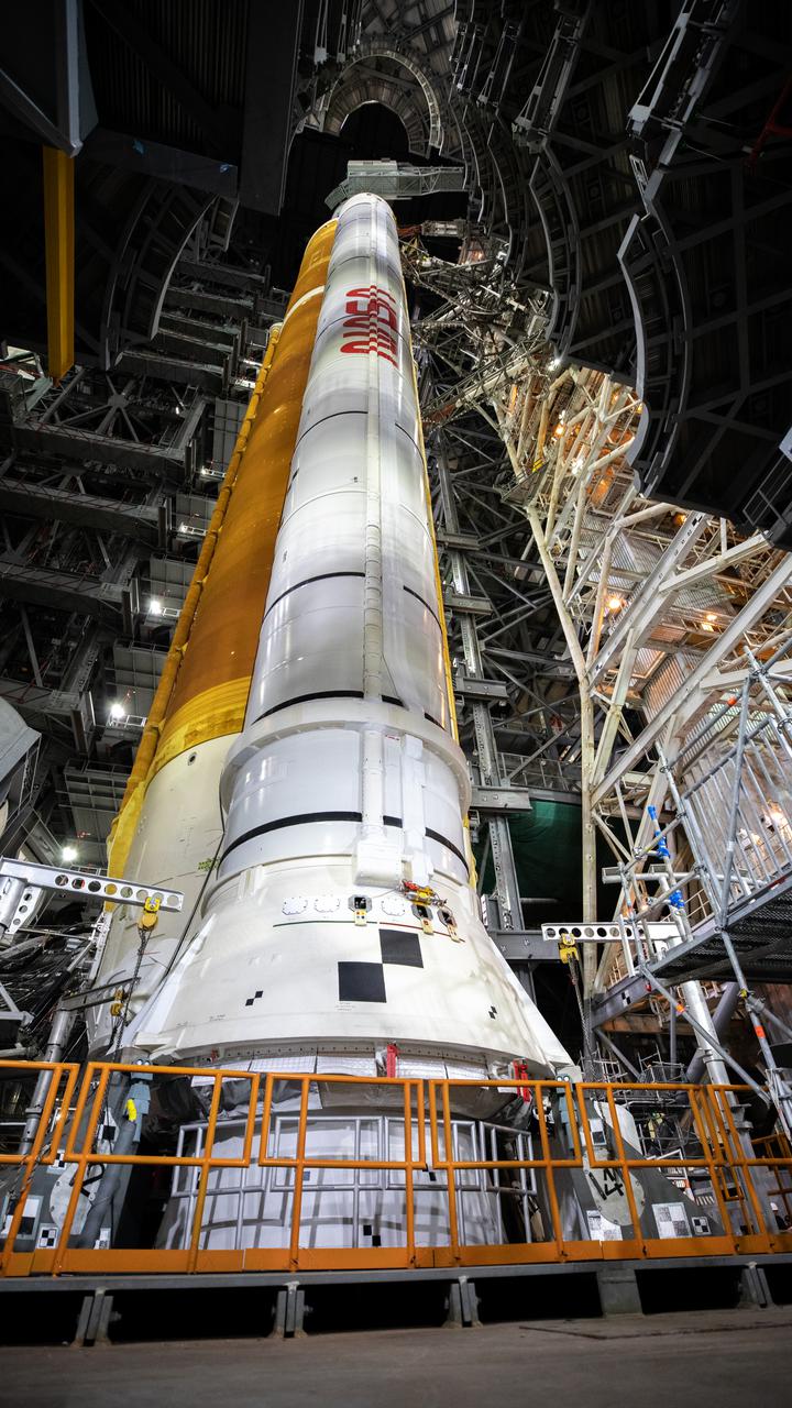 In this view looking up in High Bay 3 of the Vehicle Assembly Building at NASA’s Kennedy Space Center in Florida, all of the work platforms that surround the Artemis I Space Launch System (SLS) and Orion spacecraft are fully retracted on March 16, 2022. The Artemis I stack atop the mobile launcher will roll out to Launch Complex 39B atop the crawler-transporter 2 for a wet dress rehearsal ahead of launch. Artemis I will be the first integrated test of the SLS and Orion spacecraft. In later missions, NASA will land the first woman the first person of color on the surface of the Moon, paving the way for a long-term lunar presence and serving as a steppingstone on the way to Mars.