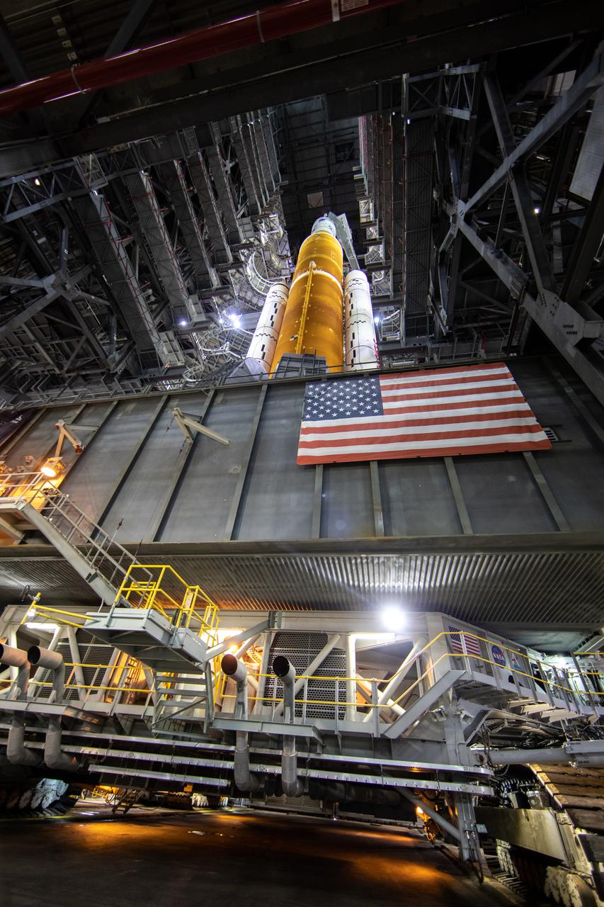 In this view looking up in High Bay 3 of the Vehicle Assembly Building at NASA’s Kennedy Space Center in Florida, all of the work platforms that surround the Artemis I Space Launch System (SLS) and Orion spacecraft are fully retracted on March 16, 2022. The Artemis I stack atop the mobile launcher will roll out to Launch Complex 39B atop the crawler-transporter 2 for a wet dress rehearsal ahead of launch. Artemis I will be the first integrated test of the SLS and Orion spacecraft. In later missions, NASA will land the first woman the first person of color on the surface of the Moon, paving the way for a long-term lunar presence and serving as a steppingstone on the way to Mars.