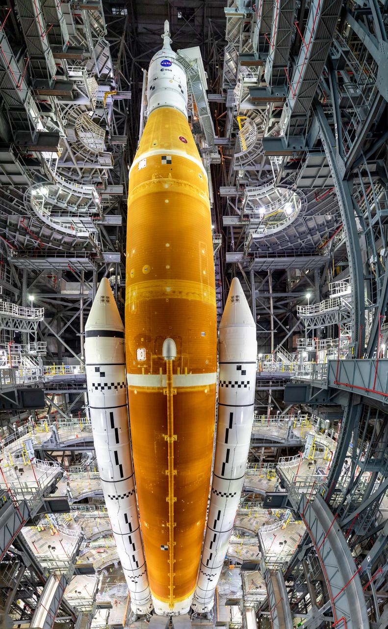 In this panoramic view in High Bay 3 of the Vehicle Assembly Building at NASA’s Kennedy Space Center in Florida, all of the work platforms that surround the Artemis I Space Launch System (SLS) and Orion spacecraft are fully retracted on March 16, 2022. The Artemis I stack atop the mobile launcher will roll out to Launch Complex 39B atop the crawler-transporter 2 for a wet dress rehearsal ahead of launch. Artemis I will be the first integrated test of the SLS and Orion spacecraft. In later missions, NASA will land the first woman the first person of color on the surface of the Moon, paving the way for a long-term lunar presence and serving as a steppingstone on the way to Mars.