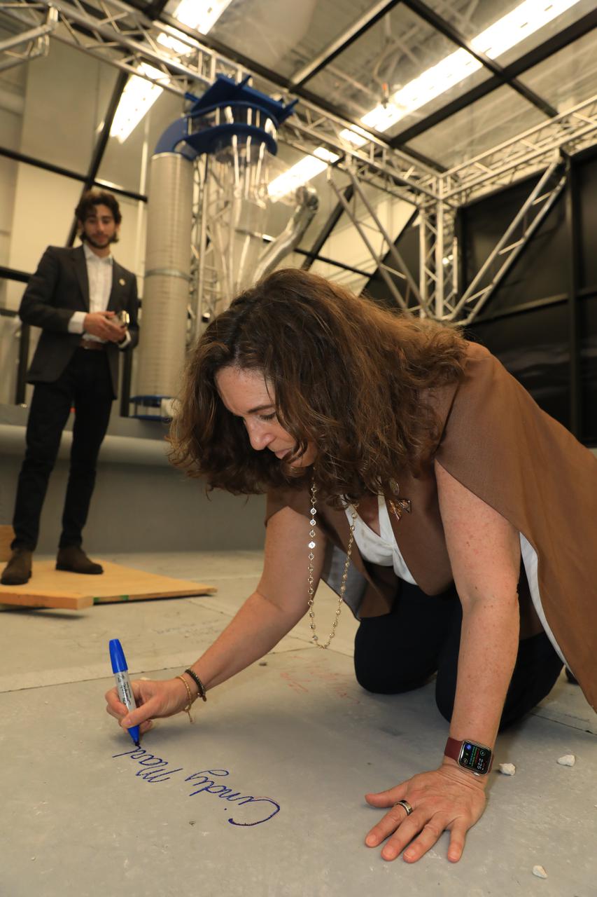 U.S. Dept. of Education Deputy Secretary Cindy Marten signs the floor of the Lunabotics arena at the Center for Space Education at NASA’s Kennedy Space Center Visitor Complex in Florida on March 16, 2022. The LUNABOTICS competition is an engineering exercise that challenges college students to develop a lunar excavator as part of NASA’s Artemis student challenges. Marten was at Kennedy Space Center to address NASA’s national partners and guests during the one-day Artemis Summit.
