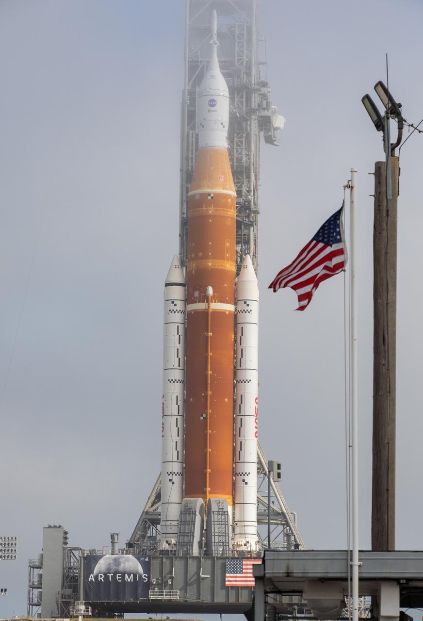 Standing atop the mobile launcher, NASA’s Space Launch System (SLS) rocket and Orion spacecraft arrive at Launch Pad 39B at the agency’s Kennedy Space Center in Florida on March 18, 2022. The Artemis I stack was carried from the Vehicle Assembly Building to the pad – a 4.2-mile journey that took nearly 11 hours to complete – by the agency’s crawler-transporter 2 for a wet dress rehearsal ahead of the uncrewed launch. Artemis I will test SLS and Orion as an integrated system prior to crewed flights to the Moon. Through Artemis, NASA will land the first woman and the first person of color on the lunar surface, paving the way for a long-term lunar presence and serving as a steppingstone on the way to Mars.