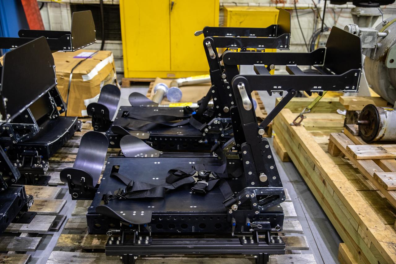 Two seats for the Artemis Orion crew module test article (CMTA) are in view in the high bay inside the Launch Equipment Test Facility at NASA's Kennedy Space Center in Florida on March 18, 2022. The seats were built by the center’s Prototype Laboratory. The CMTA is used to practice recovery after splashdown of the Orion spacecraft to prepare for Artemis missions. Exploration Ground Systems leads recovery efforts.