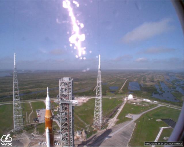 A lightning strike was recorded at Launch Complex 39B at NASA’s Kennedy Space Center in Florida during the evening of April 2, 2022. NASA’s Space Launch System (SLS) and Orion spacecraft were undergoing a prelaunch test called a wet dress rehearsal at the pad for the Artemis I mission. The lightning strike was recorded by cameras stationed at the pad and mobile launcher using a special filter called a “clear day frame,” which provides an overlay of the raw frame on a reference image. Artemis I will be the first integrated test of the SLS and Orion spacecraft. In later missions, NASA will land the first woman and the first woman of color on the surface of the Moon, paving the way for a long-term lunar presence and serving as a steppingstone on the way to Mars.