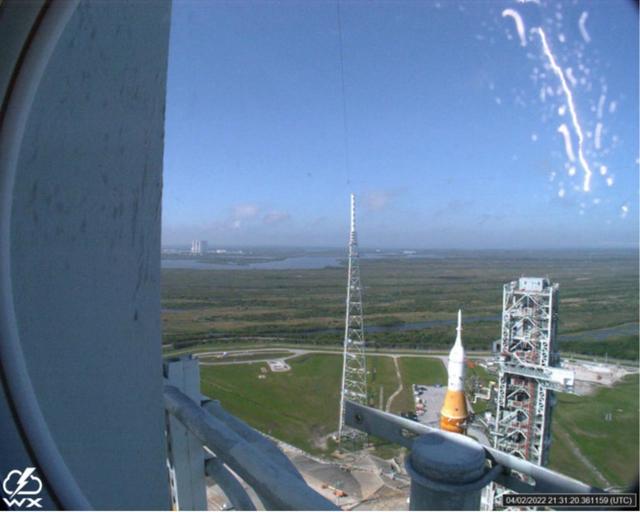 A lightning strike was recorded at Launch Complex 39B at NASA’s Kennedy Space Center in Florida during the evening of April 2, 2022. NASA’s Space Launch System (SLS) and Orion spacecraft were undergoing a prelaunch test called a wet dress rehearsal at the pad for the Artemis I mission. The lightning strike was recorded by cameras stationed at the pad and mobile launcher using a special filter called a “clear day frame,” which provides an overlay of the raw frame on a reference image. Artemis I will be the first integrated test of the SLS and Orion spacecraft. In later missions, NASA will land the first woman and the first woman of color on the surface of the Moon, paving the way for a long-term lunar presence and serving as a steppingstone on the way to Mars.